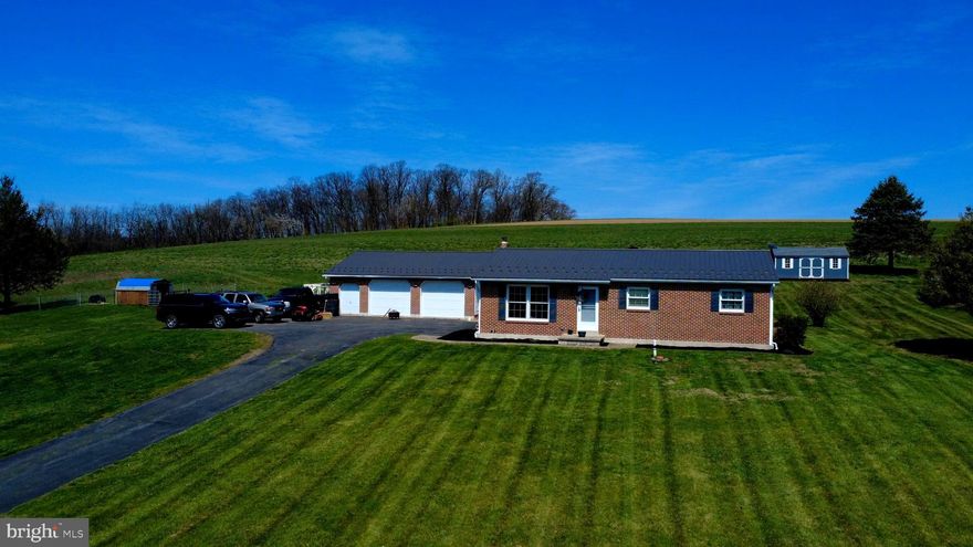Welcome to peaceful country living situated among preserved farms providing  beautiful views and plenty of open space!
 This solid, brick front ranch home has 3 bedrooms and 2 full baths on the main floor with central air cooling, vinyl windows, master bath with tiled shower, recessed lights, new water softener in 2026 and new roofs installed in 2023. Comcast and Starlink internet service available. The basement has additional rooms as well as a rec room and laundry room.
The home is situated on over 3 acres of land which includes an established hay field, spacious yards with a garden and a couple cherry and peach trees for the outdoor lovers.
There is a  brick front 3 door garage included which is both insulated and heated and has concrete floors and 40 amp electrical service.
Enjoy entertaining and bbq on the covered patio off of the garage overlooking the back yard.