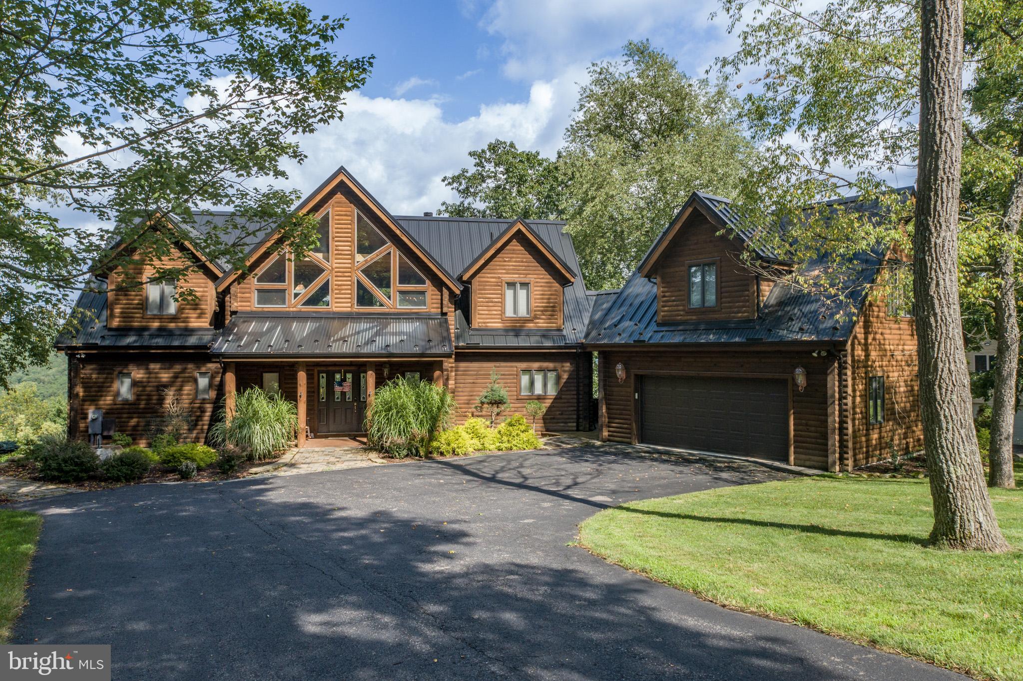 Find your dream home at the sought after address of the Highlands subdivision, which is a gated elite community on top of Marsh mountain near golf and skiing. This solidly constructed log home has 3 levels of finished living space, including 7 BR, 5.5 Bath, of which 3 are suites and 2 are jack & jill. Quality details are displayed in the spacious gathering areas, soaring windows, 2 stone gas fireplaces, open beamed ceilings and built-in bar in the family room. This lovely home features lake and mountain views and has lake access with a boat slip. There is a detached double car garage with finished space on the upper level. The hardscaping displays a large custom patio, built-in fire ring and hot tub. An outdoor pool, tennis court, basketball court and pavilion is part of the community HOA amenity package .