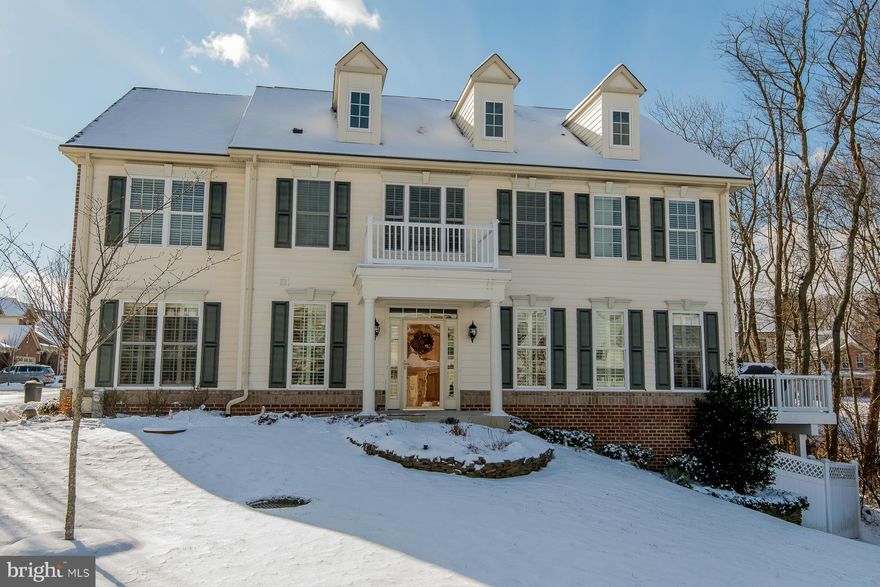 Active Adult Community. End-of-group townhome in the sought-after Enclave at Ellicott Station community. Spacious and bright, this home boasts lustrous hardwood floors, decorative moldings, an elevator for easy access to each floor & plantation shutters. FR w/gas FP & glass sliding door access to the deck, DR w/chair rail trim &  gourmet kitchen. Lower level equipped with a full bath & rec room.