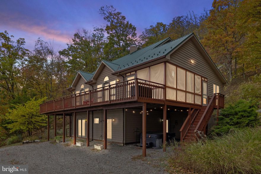 Stunning, newly-renovated five-bedroom chalet cabin with serene mountain views, surrounded by acres of trees, and on one of the most coveted lots in Coolfont.  Features high ceilings, huge windows, beautiful woodwork, a wood-burning fireplace, an open kitchen and dining area, wraparound deck, screened-in porch, and bright, airy living space.  Professionally designed with all new furniture, modern decor, and hot tub. Seller spent over $70,000 furnishing & upgrading the property.  As a vacation rental it has generated $227,000 over the past 3 years ($82,000 last year), and can come with an existing property manager and cleaner.  This cabin is located in Coolfont Resort, a private community with an outdoor pool & hot tub, and miles of hiking trails – and just 10 minutes from downtown Berkeley Springs.  Hot tub and furniture optional, available for purchase.  See seller docs for a summary of rental history and financials.  $1,000 buyer credit if you continue using the same property manager.  Perfect primary residence or vacation home!