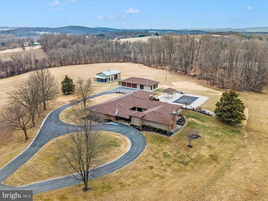 Stunning 33-Acre Estate with Two Homes and Breathtaking Views**

Discover a rare opportunity to own a magnificent 33-acre estate, featuring exquisite views and remarkable architectural design. This property is anchored by a stunning main residence designed by renowned contemporary architect Louis Ballistone, a protégé of Frank Lloyd Wright. 

**Main Home Features:**
- **Spacious Living**: This elegant estate boasts five beautifully appointed bedrooms and three fully updated bathrooms, along with two convenient half baths and a dedicated dog bath area.
- **Gourmet Kitchen**: The heart of the home, the gourmet kitchen, offers high-end appliances and generous counter space, perfect for culinary enthusiasts. Enjoy effortless entertaining with a view of the inviting underground pool and expansive patio.
- **Modern Amenities**: The residence is equipped with upgraded systems, including energy-efficient geo-thermal heating, ensuring comfort year-round. 
- **Versatile Spaces**: A three-car garage includes a workshop and bath, making it ideal for hobbyists and those in need of additional storage. The property also features a dog kennel with indoor access and runs, perfect for pet lovers.
- **Beautifully Landscaped Grounds**: The yard area is meticulously landscaped, providing a picturesque setting for outdoor activities and relaxation.

**Second Home:**
- The charming second home is a Maryland farmhouse that has seen many updates, with some repairs and finishing touches needed to bring it to its full potential. This space offers great potential for guests, in-laws, or rental opportunities.

With ample space to roam and explore, this extraordinary property combines the beauty of nature with luxurious living. Don't miss the chance to own this unique estate that is perfect for families, entertaining, or simply enjoying the tranquility of country living.