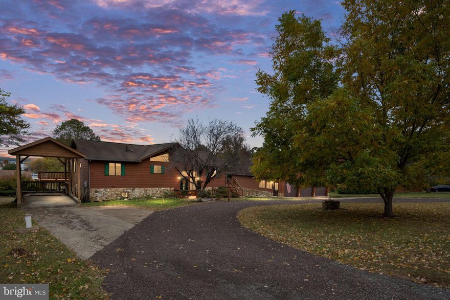 Welcome to your own lakeside getaway in one of Lake Anna’s most sought-after gated communities - Windwood Coves.  This 5-bedroom & 4 bath home offers 2,712 square feet of comfortable living space with year-round water views that will make you feel like you are on vacation every day. 
Step inside to discover a split-bedroom plan that offers privacy while the open design keeps the main level living areas flowing seamlessly together. Vaulted ceilings add dramatic height and airiness in the kitchen and family room, complemented by a genuine stone wood-burning fireplace and wood floors that promise cozy evenings after a long day on the water. The kitchen features a practical island and stainless-steel appliances, making meal prep a breeze whether you're cooking for family or entertaining guests. The primary bedroom provides a peaceful retreat, while the additional bedrooms offer flexibility for family, guests, or that home office you've been dreaming about.
Downstairs the finished basement comes complete with a bar and pool table, because apparently the prior owner believed in a work-hard-play-hard philosophy. Whether you're hosting game night or just want to practice your eight-ball skills, this space delivers entertainment in spades. Plus, the basement provides you a workshop, full bath and 2 extra rooms for guests, office space or a craft room all with water views! 
Stepping outside you will discover your personal outdoor oasis. The expansive deck that  wraps around to the front of the home, includes a screened in three-season room on the back of the home where you can soak in those stunning water views regardless of weather. The attached covered boat and recreational vehicle port keeps your toys protected, while the dedicated boat slip is just a short walk away & conveys with the property, means you're always ready for spontaneous lake adventures.
Car enthusiasts and hobbyists will absolutely love the oversized detached 5-car garage complete with a commercial car lift, full bathroom, and abundant storage space. It's practically a workshop paradise with room for projects, tools, and all those items that need a proper home.
Living in this gated community means access to exclusive amenities including a private community beach, playground, tennis, pickleball  & basketball courts and a large pavilion perfect for gatherings and recreation. The location on Lake Anna's public side provides excellent access to all the lake has to offer while maintaining the privacy and security of a well-managed community.
Convenience couldn't be better with nearby grocery shopping and diverse dining options just minutes away. Whether you're craving fresh seafood, Italian cuisine, Asian flavors, or local brewery & winery fare, you'll find it all within easy reach. The Food Lion ensures your everyday shopping needs are covered without lengthy drives.  Also, there are 2  full time Marinas just a short boat ride away making easy to  gas up the boat or utilize other services like winterizing your boat! 
The property also presents excellent renovation potential for those wanting to customize. The solid foundation and desirable location make it an ideal candidate for those needed updates that will significantly enhance its value. The natural environment surrounding Lake Anna offers endless recreational opportunities from boating and fishing to hiking and wildlife watching. This home positions you perfectly to enjoy central Virginia's beautiful lake country while maintaining easy access to modern conveniences and entertainment venues that make everyday living comfortable and enjoyable. This isn't just a house – it's your gateway to living the lake life you've always imagined.