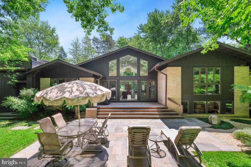 Welcome to this exquisite 4-bedroom, 3.5-bathroom residence offering unparalleled luxury and comfort in the sought-after Luxmanor community. Set on over half an acre of professionally landscaped property, this home provides a private and secluded oasis complete with a professionally designed vegetable garden and outdoor illumination. Upon entering the walk-in level, you are greeted by a welcoming foyer that flows seamlessly into the expansive living room, boasting dramatic cathedral ceilings and oversized windows that flood the home with natural light. Oak floors and recessed lighting throughout the entire home enhance the elegance of this space. The formal dining room offers serene backyard views, while the recently remodeled kitchen is a chef's dream, featuring a wall oven, convection/microwave oven, warming drawer, Sub-Zero refrigerator, 5-burner gas stove, all stainless steel appliances, custom backsplash and cabinetry, a kitchen sink outfitted with a reverse osmosis water filtration system, and a breakfast area with skylights. The family room, just steps away, includes built-in shelving, a gas fireplace, abundant windows, and cathedral ceilings, providing the perfect space for gathering. The upper level includes a full bath, a bedroom with gorgeous backyard views, and a second bedroom with built-ins, perfect for use as a home office. The generous primary bedroom features two walk-in closets and a spa-like primary bath with a double vanity, heated floors, large shower, Jacuzzi tub, and skylight. The lower level offers a large recreation space with built-in shelving, a full bedroom, a full bathroom, a large custom home office - fully equipped with high-quality built-in desks, and a laundry room with access to the backyard. Enjoy the community-centered neighborhood with an abundance of amenities and activities year-round. There's something for everyone with a community pool, active swim team, tennis courts, a local park, and hiking trails. Close to unlimited shopping, dining, and entertainment venues, including Pike and Rose and NoBe Market, this one-of-a-kind home offers the best of North Bethesda!