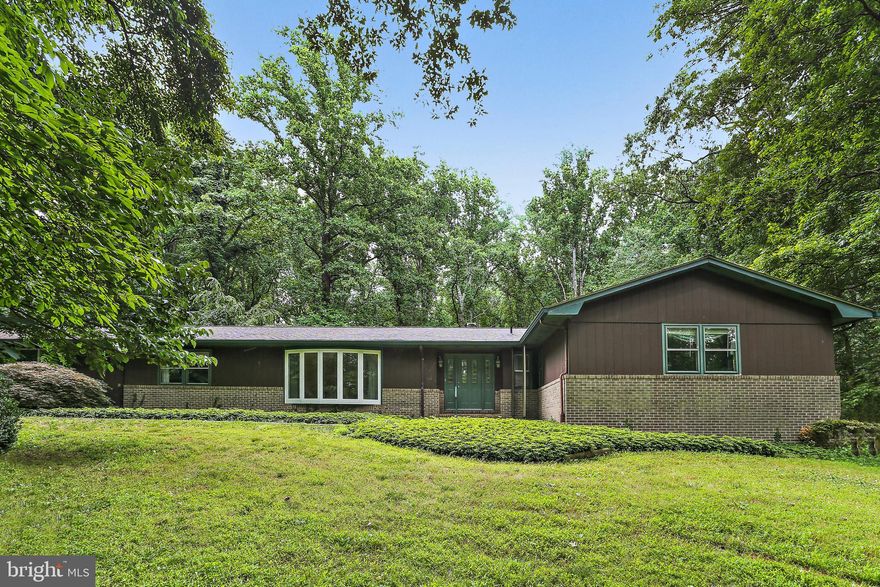 MAKE AN OFFER! Privacy  and tranquility abound in this sprawling rancher . Enjoy its spacious 2+ acres of woods and 4+ car garage.    With 4 Bedroom & 3.5 bath this rancher  has over  2200 sq ft on the main level.   Large Front Foyer as you enter the  house.  Modern kitchen with SS Appliances including 3 door Refrigerator Freezer and built in microwave. Corian countertops and Cherry wood cabinets in the kitchen. Large breakfast island with seating and a skylight to brighten your day. Family Room with skylight and wood burning fireplace next to Kitchen that  leads to a huge composite deck  and patio area.  Hardwood floors thru house under carpet  Separate Dining Room   Living Room with Large Bow window   Large Primary Bedroom with  Big closet plus a walk in closet  Primary bathroom has large vanity,  shower and potty room. 3 other generous bedrooms with good sized closets. Hall bathroom with skylight. Main laundry room and half bath is on the main level off the kitchen and  oversized 2 car garage.
Large basement is partially finished with a potential additional laundry room, full bath and rec room etc.
Plus there is an oversized 2 car+ garage in the lower level.. There is some wallpaper in the house but  Boy the space and location!!!  Come and see for yourself.