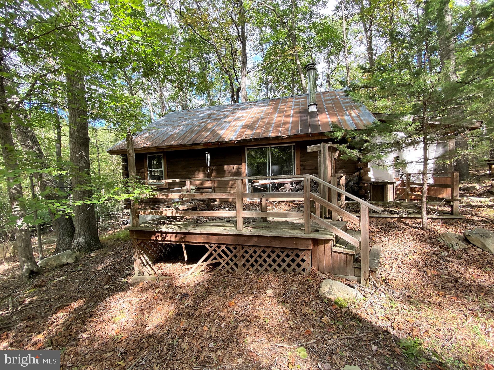What a great opportunity to drive past the magnificent Warden Lake everyday on your way home to your log cabin. This two bedroom one bath log cabin with loft does need some TLC, the electric hasn't been on for several years. But once you're done it will be well worth it! When your not spending time at the lake, you can just relax on the deck and enjoy the wildlife on this 6.2 acre lot. Nice little storage shed for storage or work shop. In the winter you can cozy up beside the wood stove.