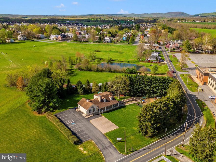 Exceptional opportunity in a prime location.  Positioned on almost an acre lot near Carroll Manor Elementary School and the prestigious Green Hill Manor neighborhood, this beautifully renovated building offers over 3,000 square feet of versatile space. The main floor features four large rooms, a reception area, and three half-baths, suitable for a variety of activities. The upper level is currently used as office space and storage, while the lower level provides two additional large rooms and a bathroom. Adding to its appeal, the property includes ample parking, accessibility ramps for ease of access, a generator that can be used in the event of a power outage, and a secure fenced-in area.