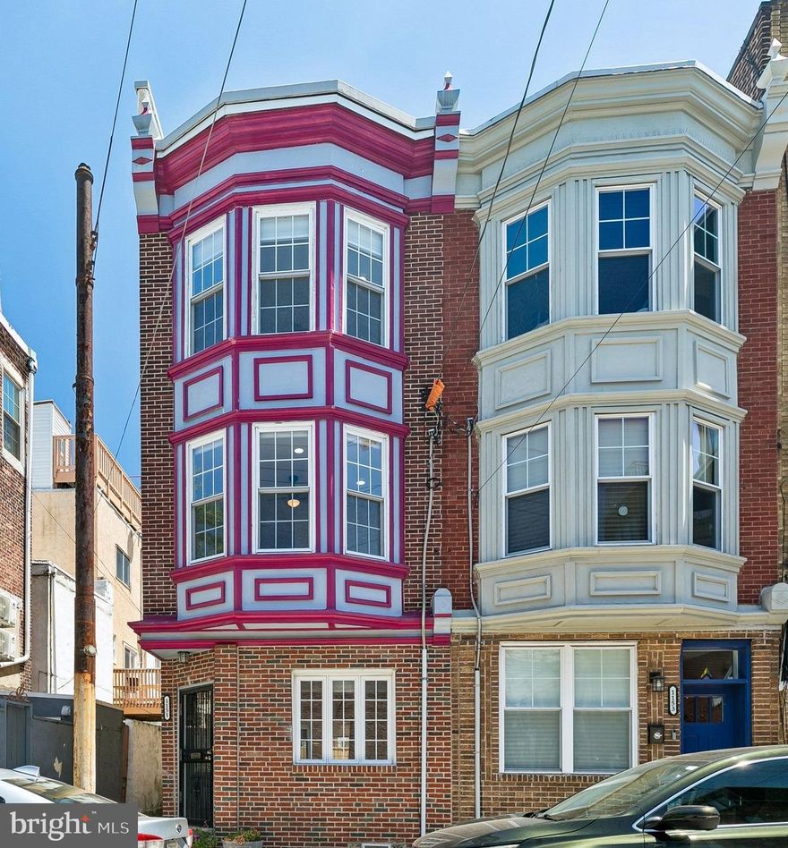 OPEN HOUSE SUNDAY, 5/17 11-1:30! For the urban dweller who craves natural light, private outdoor space and close proximity to parks, your search ends here! 1151 S 13th Street is a striking 3 bedroom, 2.5 bathroom END-OF-THE-ROW home which boasts smart and stylish upgrades throughout, set in one of Philadelphia’s most coveted neighborhoods, Passyunk Square. As you stroll this beautiful tree lined street, you will notice that this home’s exterior facade establishes its sense of distinction, setting the tone for the home's modern transition inside. Elegant decorative cornices crown the structure while the multi-story colorful bay windows add extra square footage and light to the homes interior and striking curb appeal outside. The immediate sense of warmth captures you the moment you step onto the brand-new, wide-width luxury vinyl plank flooring that spans the entire open-concept first floor. Because this premier end unit enjoys an open walkway along its side perimeter with no direct neighbor, oversized windows surround the main level from front to back, flooding the expansive living area with an abundance of natural light. At the heart of the home is a gorgeous kitchen designed for effortless entertaining. It comes fully equipped with premium two-toned shaker cabinetry, high-end quartz countertops, a central island, new appliances, and thoughtful upgrades like a pantry closet and a pot filler. Just off the kitchen sits the first of THREE PRIVATE OUTDOOR SPACES, featuring a spacious grilling patio with its own rear exit (making trash day completely effortless). A nicely appointed powder room completes this main living level. Moving upstairs, the second floor serves as a blend of comfort and utility. Two generously sized bedrooms each offer double closets and are situated on either side of the house, sharing a tiled centrally located bathroom complete with a relaxing jacuzzi tub and shower combination. For ultimate convenience, this level also features a full sized laundry room with built-in storage which is not always easy to find in the city. The entire third floor is dedicated to a lovely primary sanctuary. The spacious corner bedroom is wrapped in windows and it connects seamlessly to the walk-in closet and an updated, tiled ensuite bathroom. Down the hall, a private door opens to a third-floor deck protected by brand-new TPO roofing. From this vantage point, steps ascend to a fabulous, EXPANSIVE ROOF DECK that crowns the property, creating a spectacular multi-tiered outdoor space for entertaining under the city skyline. Completing this exceptional residence is a clean, pristine basement with a direct bilco door exit to the street, and many other attractive features like modern LED recessed lighting throughout and ceiling fans tailored for comfort. Don't forget the unbeatable location. Steps away from East Passyunk Ave's “Restaurant Row” with its award winning dining, charming cafes boutique shops and also the famous Italian Market. It's close to public transportation for quick access to the stadiums, and steps to popular Columbus Square Park which boasts a dog park, playgrounds and many community events. This is not just a home, its a lifestyle - comfort, convenience, fun and 94 walk score! Make your appointment today!