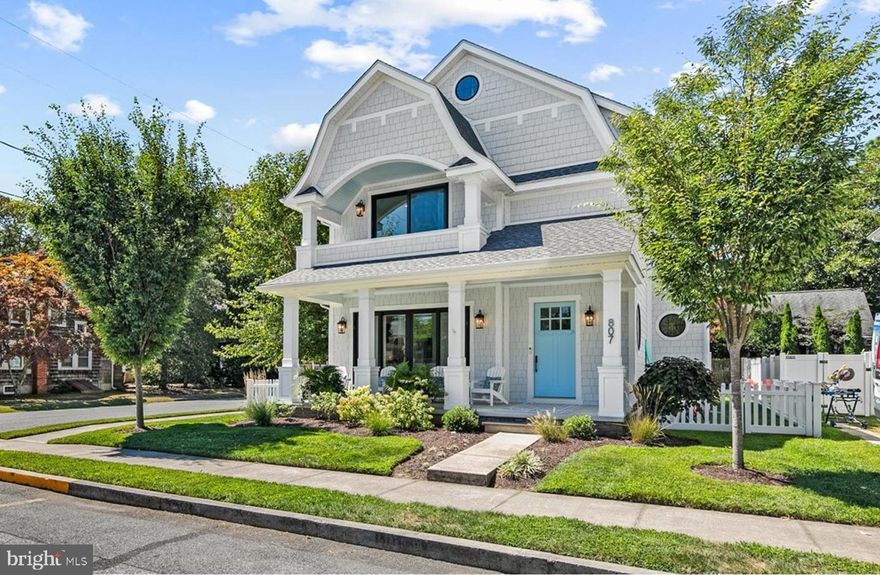 Coastal elegance meets modern convenience in this stunning custom home, ideally located just one block from Rehoboth’s award-winning beaches and iconic boardwalk. Perfectly positioned at the corner of King Charles Avenue and Rodney Street, this residence showcases a chic coastal elevation with Hardie shake siding, graceful gambrel rooflines, and a spacious, welcoming front porch. Inside, a sought-after open-concept floor plan offers 5 bedrooms, 5 full baths, and 1 half bath across two thoughtfully designed levels. The first floor boasts soaring 10’ ceilings that flood the home with natural light, highlighting timeless finishes such as wide-plank walnut floors, a gas fireplace with shiplap and tile surround, coastal-inspired lighting, and coffered ceilings. The gourmet kitchen is a chef’s dream, featuring abundant cabinetry, sleek quartz countertops, a walk-in pantry, an oversized island, and a premium Dacor commercial-grade appliance package. Just off the kitchen, a sunny rear deck provides the perfect space for grilling and outdoor gatherings. The first-floor primary suite offers convenience and comfort, complete with a spa-like ensuite bath and access to the rear deck. A laundry room (hookup only) rounds out the main level. Upstairs, 9’ ceilings create an airy feel throughout four additional bedrooms, each with its own private ensuite bath. A central loft with access to a private balcony provides a cozy second living area, complemented by an additional laundry closet with stackable washer/dryer. Though never rented, this property offers exceptional rental potential – making it equally ideal as a year-round residence, vacation retreat, or investment opportunity.