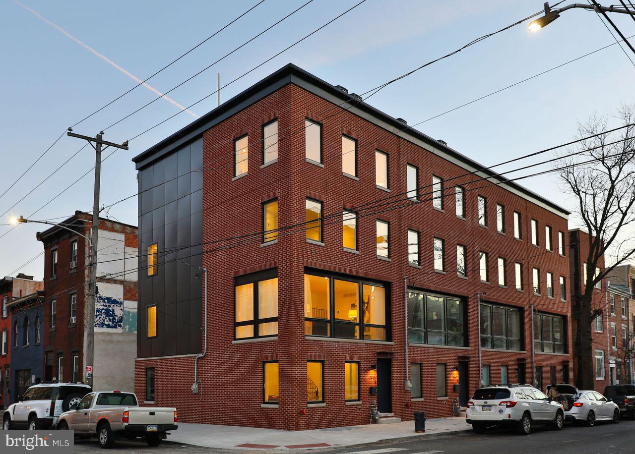 This new construction, 4-bed, 3 bath designer home spans over 3,200 SF, combining sophisticated design, thoughtful layout, and effortless livability in one of Philadelphia’s most desirable neighborhoods. With a generous 20-foot wide corner lot and triple exposure to the east, west, and north, this home is flooded with natural light. The entry level features a versatile first-floor suite with a full ensuite bath and walk-in shower—ideal as a private guest bedroom or home office. A spacious mudroom with side-by-side laundry leads to an oversized garage with epoxy flooring and an EV charging outlet. Upstairs, the second floor reveals a stunning open-concept living and dining space framed by floor-to-ceiling windows. The adjacent chef’s kitchen is a showpiece, outfitted with sleek European-style cabinetry, stone countertops, and premium GE Café appliances. The third level offers two generously sized bedrooms and a beautifully appointed guest bath with a dual vanity and soaking tub. The primary suite has it all, complete with oversized windows, a custom walk-through closet, and a spa-inspired ensuite bath that includes a freestanding tub, glass-enclosed walk-in shower, and dual vanity. A built-in wet bar on this floor leads to a private rooftop terrace with breathtaking panoramic views—ideal for hosting friends or relaxing under the stars. The fully finished lower level is a flexible space that can serve as a media room, home gym, or guest quarters, adapting to your lifestyle needs. Just a short walk away from culinary destinations like Suraya, Pizzeria Beddia, Post Haste, Laser Wolf, Picnic, Little Walter’s, and Rowhouse Coffee. FULL TEN YEAR TAX ABATEMENT and ONE YEAR BUILDERS WARRANTY. Schedule your private tour today.