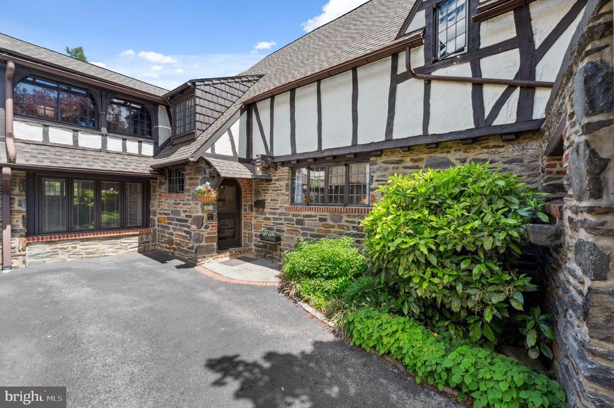 Welcome to 410 Arthurs Round Table, an exquisite 1924 historic residence nestled in the enchanting English Village neighborhood in Lower Merion. English Village, named to the Architectural Hall of Fame by the Lower Merion Conservancy, is a desirable enclave of 29 homes built by renowned architect S. Arnold Love and his brother, designed to emulate a 16th century English Cotswold Village. This elegant twin home boasts over 2,800 square feet, four bedrooms and two and a half bathrooms, showcasing an impeccable pride of ownership and timeless charm. Upon entering, you are greeted by the allure of gorgeous, original hardwood floors that flow seamlessly throughout the home. The first floor unfolds into an updated eat-in kitchen, where granite countertops and a Mercer tile backsplash complement the space beautifully. Enjoy meals in the dedicated dining room, illuminated by new recessed lighting, or relax in the living room by the warmth of the gas fireplace and original moldings.  Through leaded glass French doors, you will find a delightful four-season (with heat and A/C) sunroom, which extends the living area, and a versatile family room/office with carpeting and built-in shelving. An updated half bath with wainscoting and a new laundry/butler’s area complete this floor. The second level features four spacious bedrooms and two full bathrooms. The primary suite includes a spacious bedroom and an en-suite bathroom with a stall shower. The second bedroom shares a jack and jill bathroom (with tub) with the third bedroom and  offers a charming enclosed side porch, perfect for a tranquil office or reading nook. Outside, the property is a gardener's dream, featuring stunning landscaping and a raised vegetable garden complete with its own irrigation system and a beautiful blue stone patio. This home's meticulously maintained gardens and specimen plantings create a serene oasis in your own backyard. At 410 Arthur’s Round Table, you have the best of both worlds, historic charm with modern updates. Situated in one of the most convenient, walkable neighborhoods, close to Suburban Square, Lower Merion High School and both Ardmore and Wynnewood train stations. Won't last!