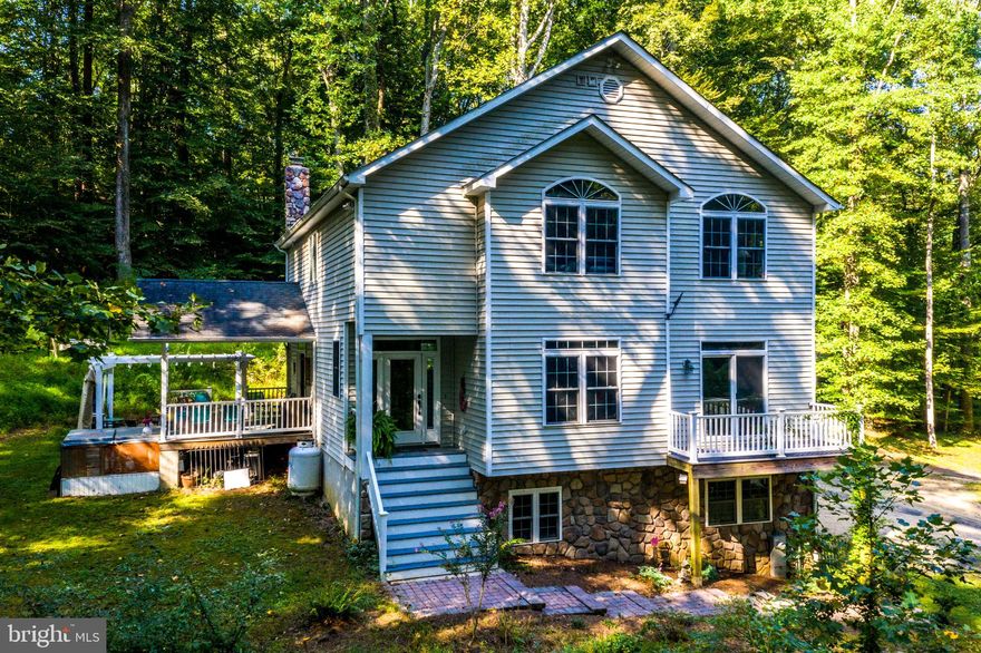 BIG REDUCTION! FEELS LIKE YOU ARE AT A MOUNTAINTOP RESORT! Outstanding Annapolis custom home tucked away on 4 rolling acres at the end of private road and surrounded by 27 miles of mountain biking and hiking trails and abuts Annapolis Waterworks Park with trails, picnic areas and 3 freshwater ponds for fishing. Wonderful open concept plan perfect for entertaining, w/ large kitchen island, built in bar, porch and patio bring the outdoors into the rooms for a perfect flow. Master Suite connects to over sized room used as office or sitting room and features Master Bath with separate shower,  soaking tub and walk in closets. Guest Bedrooms with connecting Jack & Jill Bath. Natural lighting streams in through all the added windows to take full advantage of the wood views. Lower level features full Bath, Den and Bedroom all at ground level along with access to oversized two car Garage. An additional  working barn that could house six cars for the collector or construction equipment. You can even continue to raise chickens in your very own coop. Feels like the country living, with a 5 minute drive to Annapolis Mall. This is the perfect arrangement for biking enthusiast or in-home business owner with no restrictions on parking machinery, trucks, bikes and equipment. Where is the builder that needs room for all their tools? Perfect hide away with space to grow.