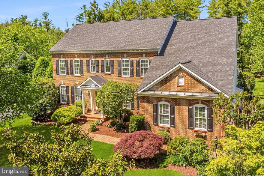 Discover the serene elegance of Quail Pond Estates with the Potomac model by NV Homes—a distinguished colonial masterpiece offering an extraordinary living experience. This impressive five-bedroom, five-and-a-half-bathroom home spans over 6,500 square feet of luxurious living space, set on a prime .64-acre lot surrounded by lush, mature landscaping that showcases exceptional privacy and beauty.  
<br><br>
From the moment you arrive, the home’s stunning brick facade commands attention, complemented by a newly resurfaced driveway and new roof with architectural shingles, enhancing its curb appeal. The property’s mature trees and meticulously maintained gardens create a verdant retreat, embodying timeless charm and a welcoming ambiance. This residence is a celebration of luxury, comfort, and sublime outdoor living.  
<br><br>
Step inside to a world of refined elegance, where open living spaces are adorned with intricate moldings and exquisite trim work that highlight the architectural brilliance throughout. Gleaming hardwood floors lead you through the generous foyer, formal living and dining rooms and into the heart of this home.    
<br><br>
The gourmet kitchen is designed for functionality and style, featuring a spacious granite-topped island with seating and storage, perfect for meal prep and casual dining. Chefs will delight in the gas cooktop and double oven, which facilitate all culinary endeavors. Ample granite counters, complemented by a stylish tile backsplash, and surrounded by upgraded cabinets, ensure maximum storage and a sleek appearance. This kitchen is not only a cook’s dream but also a central gathering spot for entertaining and everyday living.  
<br><br>
Adjacent to the kitchen, a sunlit morning room with soaring cathedral ceilings provides an inviting space for informal dining. The seamless integration of entertainment and relaxation is beautifully showcased in the spacious family room, featuring a warm gas fireplace as its centerpiece. For year-round enjoyment, a fully enclosed, insulated porch serves as a tranquil retreat, perfectly complementing the home's luxurious ambiance. Additionally, the main level boasts a functional mudroom and a home office, adding layers of practical elegance to the home’s thoughtful design.  
<br><br>
The journey continues upstairs to the exquisite primary suite, which features a sitting area framed by elegant columns and a tray ceiling, leading into a lavish bathroom with a deep soaking tub and dual vanities. The architectural design includes a unique 'gallery' around the central staircase on the upper level, which enhances the open, airy feel and provides access to all rooms. Completing the upper level is an en-suite bedroom with full bath, and two additional bedrooms sharing a Jack-and-Jill bathroom. Additionally, this highly desirable floor plan encompasses a finished attic with recreation room, bedroom, and a full bathroom.  
<br><br>
The lower level of the home is equally impressive, with a huge recreation room, guest suite, and full bathroom, all with new carpet and paint. It’s the perfect setting for hosting guests or family movie nights. The incredible outdoor space is highlighted by a large flagstone patio with outdoor kitchen and bar. Rarely available in the heart of Ashburn, this large lot encompassed by mature trees, provides ample space for outdoor activities or even a future swimming pool. The practicality of this estate is rounded out by a three-car side-load garage, adding to its refined utility.  
<br><br>
Perfectly positioned for convenience, this estate is less than a mile from the Silver Line metro, offering quick access to commuter routes and blending suburban tranquility with effortless urban access. Located in sought-after Loudoun County, minutes from schools, shops, restaurants, and entertainment venues, this home at Quail Pond Estates represents the pinnacle of sophisticated living—where luxury meets comfort in every detail.