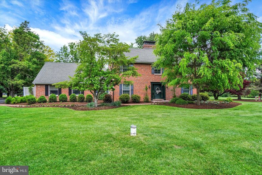 Set back a long driveway in the middle of 5.5 acres of peaceful privacy you'll discover this one owner custom built all brick 2 story Salt Box style home boasting 4 Bedrooms and 3.5 bathrooms affording space for the entire family. This well thought out floorplan is inclusive of a  first floor primary suite and a private guest suite. This first time offering is located in one of York County's most desirable locations based on an abundance of peace and privacy and minimal traffic , yet only minutes from all major traffic routes and shopping venues.  As for the special features of this home, there are many. Let's start in the gourmet kitchen , which has been nicely updated to include custom cabinetry, gorgeous granite tops, large spacious island, custom gas stove top, built in double oven, built in Bosch microwave and a Brick Fireplace for added ambiance. Off the kitchen are 2 cozy spaces to be used as either dining or sitting rooms, whatever your fancy. Next let's move to the large first floor family room that features a wall of custom built in cabinetry, a wet bar, warm hardwood floors and a very nice exclusive in home sound system that will stay for the new owners enjoyment. Adjacent to the family room is a workspace/ office area plus a laundry room and powder room, both conveniently placed for ease of access. Still on the main floor, discover the primary owners suite boasting a newly updated bath and ample sized walk in closet plus beautiful hardwood floors. On the second floor is an open loft looking over the kitchen area plus 2 more private bedrooms , both with hardwood flooring and a full bath. Don't forget the very private guest suite with it's own bath with heated floors, sure to please the tired traveler who seeks shelter from the storm, or just your own overnight guests or family member! In addition to all this, there is finished space in the lower level for games, exercise, etc. which also includes extra kitchen space for canning or entertaining. For your vehicles and yard equipment, there is a large 3 bay garage with a full second story workshop, perfect for the craftsman or gardener. No worries here  on the major systems of this well maintained property as the roof on the house and garage were replaced in 2009 with 50 year shingles, the heating system has been replaced and upgraded to a 4 zone state of the art propane fired super efficient hot water design in 2025, the original septic system has been completely replaced with a modern peat tank filtering system, the hot water heater replaced with a Rheem Performance Platinum Hybrid Heat Pump Water Heater and the well pump was replaced in 2025. Did I mention that all windows were upgraded to Andersen Series A units? There is a 1000 galloon underground propane tank that is owned by seller, allowing you to choose the propane supplier you prefer. To top it all off, there is lush landscaping and thoughtfully placed flower beds for the plant and gardener lover. All in all, this is a rare opportunity to obtain a well built, well maintained and upgraded family home offering acreage, privacy and convenience in one package. Come see for yourself, you won't want to leave.