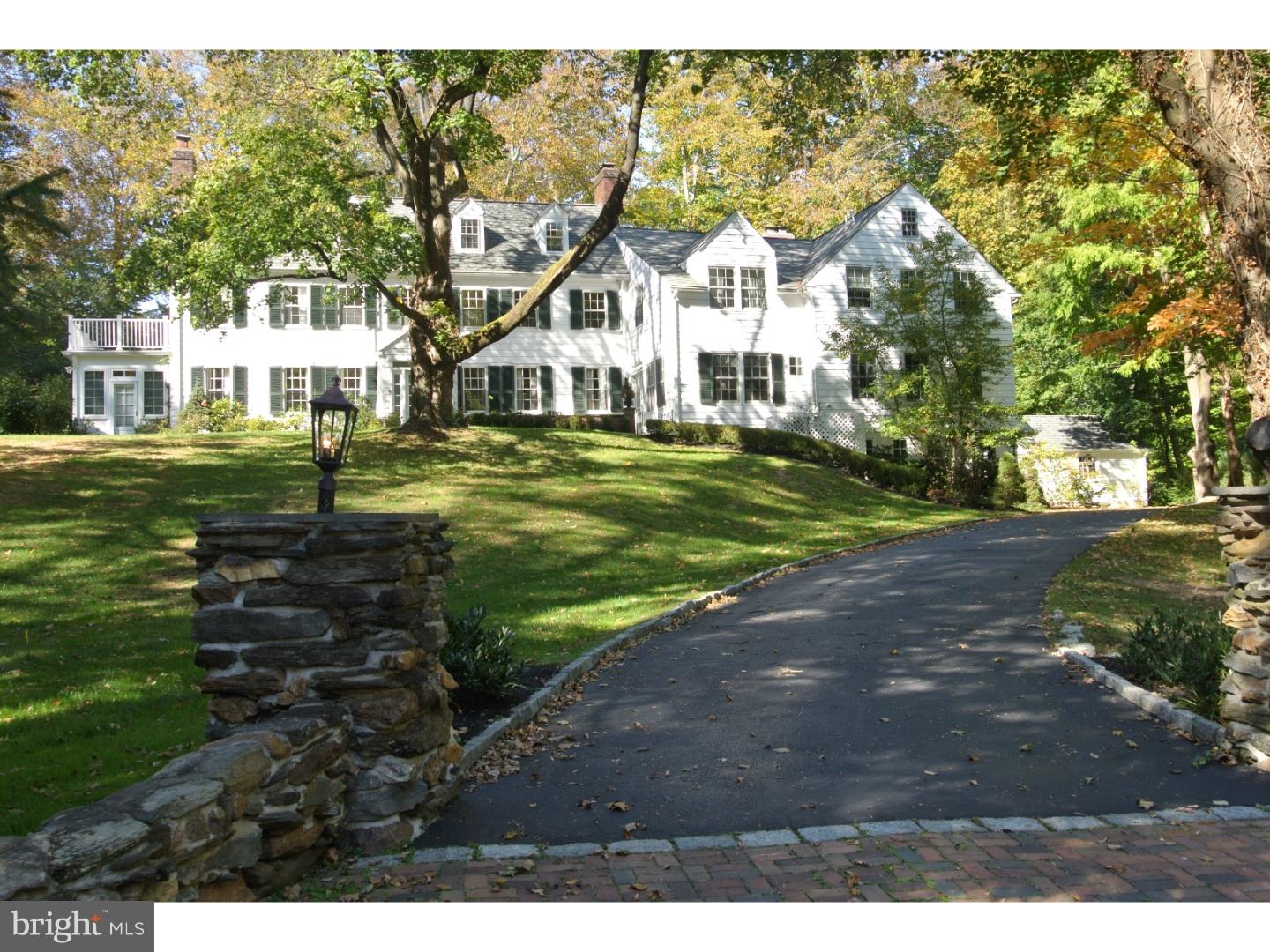A Classic Main Line Colonial, with low taxes, totally renovated to accommodate today's lifestyles. The original clapboard house was built in 1927 for Charles Mather and was called "Avonwood Lodge".Charles Mather a Main Line scion, was the owner of the historic "Avonwood Court", an Edwardian manse, and built "Avonwood Lodge" as a wedding gift. The home is one of the Main Line's premier properties sitting directly across from the Brentford Gates. The property,on over an acre of wooded land, is bordered by "Trout Run" stream. The house is a classic 3 story colonial that has undergone extensive renovations over the last 22 years. The first addition to the home in 1928, added a 2 story addition - a bedroom, bath and kitchen. In 2004 construction nearly doubled the size of the house adding another addition with a 3 car attached garage, 3 bedrooms, a new bath, 2 offices , a universal bath and a mudroom. There is also a detached 2 car garage, 2 slate patios, and outdoor fireplace in addition to the 5 indoor fireplaces. The gunite pool was built by Armond Aquatech. There is a southern exposure sunroom, a partially finished basement with separate laundry room, and there are 2 more laundry areas on the second floor. The kitchen and bath cabinetry was designed and installed by Petersen Kitchens of Bryn Mawr. The house sits on a wooded lot accessed by a winding drive. Installed on the property are lawn sprinklers and a generator. The tree trunk wood carving was created by Marty Long for the owners. Owner has a PA real estate license. Please view the drone videos!