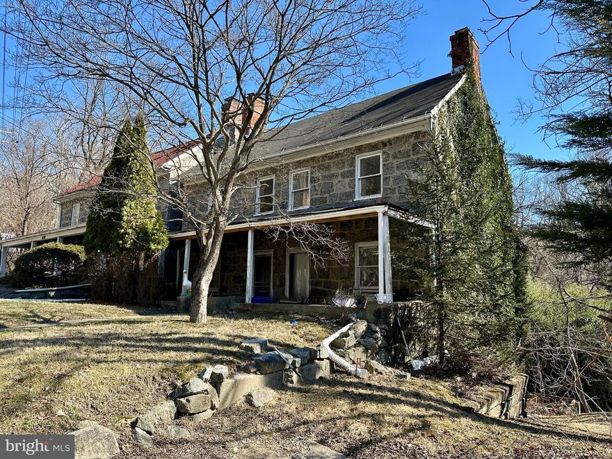 Between Old Ellicott City and Catonsville, this stone home is a project for old home lovers and investors. The home features two fireplaces anchoring each end of the house, and deep-set windows that showcase the solid stone construction. The kitchen and dining area, once the heart of the home, retains its original wood-burning fireplace, a testament to its warm and inviting past. Overlooking a feeder stream to the Patapsco River, the property offers stunning seasonal views, where generations made summer memories—napping in the screened porch or enjoying the sounds of nature. This diamond in the rough is brimming with potential, offering a rare chance to restore a stone home and create something truly special. This one-of-a-kind property awaits your vision. The property is sold in As Is condition and the boiler does not work - the house needs work - the seller will not make repairs.
