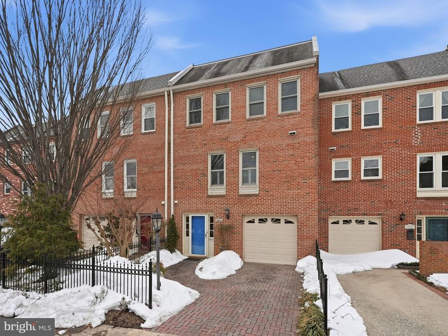 Ideally located in McLean Park Manor within walking distance to McLean High School, this interior brick townhouse offers timeless curb appeal with a brick paver driveway and walkway, plus a one-car garage. While the home carries a Westmoreland Street address, the driveway and main entrance are accessed from a parallel access road, creating a separate, dedicated entrance for daily arrivals and departures.

Inside, enjoy over 2,000 square feet with 3 bedrooms, 2.5 baths, and hardwood floors on the main and bedroom levels.

The entry level welcomes you with a wide, spacious foyer featuring large-format ceramic tile, a coat closet, powder room, and direct garage access, plus open stairs leading to the main level. The front entry is east-facing, and the entry-level rec room is a true standout—complete with a wood-burning fireplace with an electric insert (the insert can be removed to return the fireplace to wood-burning) and a full wall of built-in bookcases, lower cabinet storage, and a built-in desk—ideal for work, play, or movie nights. Under-stair storage includes built-in wine racks, and double French doors open to a private, fenced backyard featuring a Pennsylvania flagstone patio and walkway to the back gate—creating an effortless indoor-outdoor flow.

On the main level, hardwood floors continue through an exceptionally large dining room that anchors the home and makes entertaining easy. The layout flows beautifully into the living room through two separate openings—one on each side of the fireplace—creating an open feel while still defining each space. The living room spans the full width of the townhouse and features a wood-burning fireplace. The kitchen offers gorgeous maple cabinetry, plenty of room for a kitchen table, and a large pantry for excellent storage.

Upstairs, the primary suite features an amazing walk-in closet, and all three bedrooms include closet storage organizers. Recent updates include fresh paint, new lighted bathroom mirrors, new bathroom lighting, and a brand-new double-sink vanity in the primary bath. Storage is abundant throughout, including an attic with pull-down stairs and flooring for added storage. Notable ages: water heater (2024), washer (2025), dryer (2020), microwave (2025), stove (2022), and refrigerator (2020). A beautifully maintained home in an unbeatable McLean location—don’t miss it.