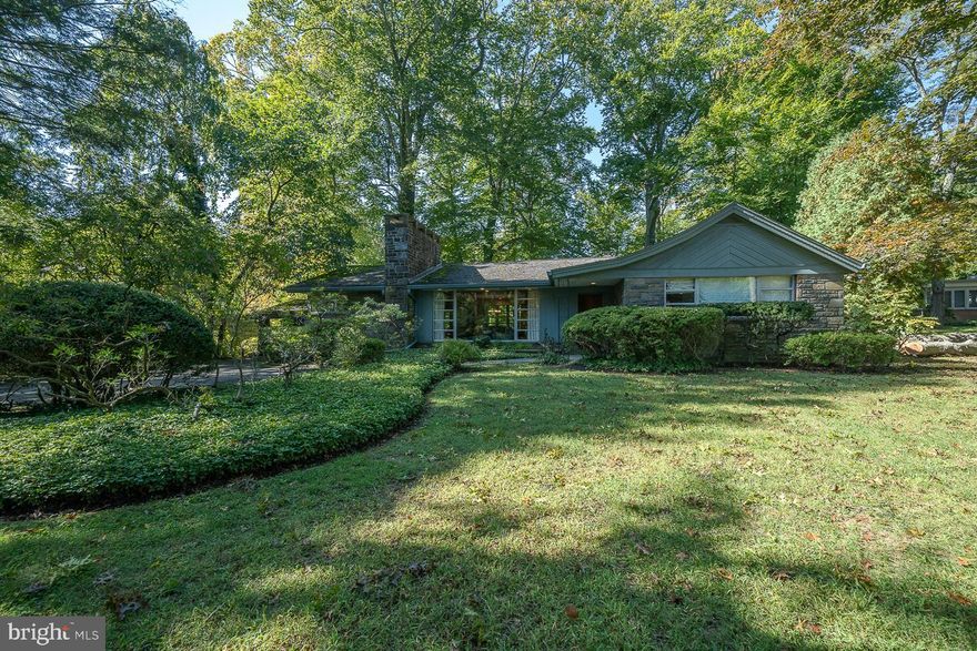 Don't miss this opportunity to update and make it your own or build new on a serene 1.66-acre lot in Penn Valley!  This Mid-Century contemporary home features 5 bedrooms and 4 full baths.  The open-concept living and dining room is flooded with light from the floor-to-ceiling front window and shows off the hardwood floors that flow throughout the 1st floor.  The 2-sided stone, wood-burning fireplace creates a warm ambiance in both the living room and adjacent family room with a built-in bar, exposed beams, and access to the back patio for enjoying the park-like setting beyond.  The updated eat-in kitchen has a skylight, granite countertops, stainless steel, top of line appliances including a 6-burner gas cooktop, GE Monogram refrigerator, and a double wall oven.  A laundry room sits conveniently off the kitchen.  The primary bedroom suite offers gorgeous views through the large corner windows and boasts a walk-in closet and updated full bath with double vanity, a soaking tub, and a walk-in shower.   Bedroom with full ensuite bath, 2 additional bedrooms, and another full hall bath with 2 pedestal sinks complete this level.  The finished lower offers a spacious 2nd family room, a 5th bedroom or office with a full ensuite bath and kitchen area.  In addition, there is a recreation/game room, a cedar closet, and tons of storage.  The grounds speak for themselves with the sounds of the stream and wind through the trees.  Stroll down the path to the secluded pool area and enjoy the quiet and beauty this property exudes.  Located in the Award Winning Lower Merion School District.  This home is close to shops and dining and an easy commute to 76 and Center City.  Schedule your showing today.