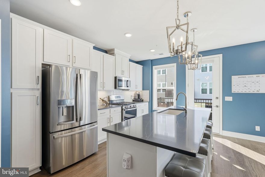 Why wait for new construction? This spacious 4-level townhome-style condominium in Goose Creek Village is just 2 years old and features an open floor plan with gorgeous wood flooring and an abundance of natural light. The main level offers a bright, open-concept layout perfect for entertaining, with a gourmet kitchen equipped with white shaker cabinets, quartz countertops, stainless steel appliances, a large island, and a pantry. A balcony just off the kitchen adds an inviting outdoor space.
The primary suite occupies its own level and provides a private retreat with a large walk-in closet and a beautifully updated bathroom with a soaking tub and a spacious walk-in shower. The fourth level offers  2 additional bedrooms and full bath, ideal for guests and/or a home office.
Located just steps from The Village Center with over 40 retailers, dining, and lifestyle amenities, and close to major commuter routes, including the Silver Line Metro, Dulles Toll Road, Route 7, and Route 28. Convenient to Dulles, Reagan, and BWI airports, as well as nearby destinations such as Ashburn Station, Brambleton, One Loudoun, and additional retail and lifestyle hubs. Rear-loading garage included. This property offers a perfect blend of luxury, convenience, and modern living.