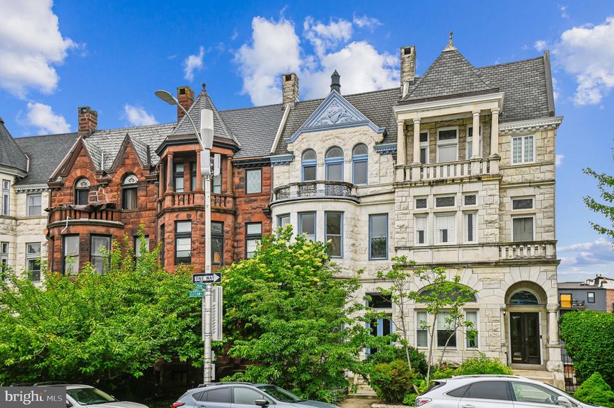 Discover this remarkable Romanesque Victorian residence in the highly sought-after area of Historic Reservoir Hill. This 4-5 bedroom, 3.5 bathroom home is characterized by an exquisite stone facade, and is adorned with a wealth of preserved original details, showcasing craftsmanship that truly stands the test of time.

As you enter, you are greeted by a grand foyer featuring a pier mirror, a handcrafted stairway, and elegant parquet flooring that flows seamlessly throughout the home. To your left, the formal living room captivates with its wood-burning fireplace, pocket doors, and stunning stained glass, revealing the incredible architectural detail that remains present in every inch of this magnificent space.

Adjacent to the living room, you'll find a gracious sitting room highlighted by another grand pier mirror. This area perfectly separates the living and formal dining rooms, which boast a built-in china and crystal cabinet, an antique gilded mirror, and another inviting wood-burning fireplace. Picture yourself entertaining up to 14 guests as you share memorable meals and conversations in this nostalgic setting.

Continuing down the hall, you will discover a laundry room and a half bath, as well as an updated kitchen designed for both functionality and style. This chef's haven includes a large island with seating, ample custom cabinetry, open shelving, top-of-the-line appliances, and a back staircase that leads to the second floor. The kitchen benefits from large windows that pour in natural light, and just outside the back door, a spacious, sun-drenched deck awaits, offering the perfect spot for additional entertaining or for gardening enthusiasts eager to cultivate herbs, vegetables, and flowers.

Moving to the second floor, the large primary bedroom features its own wood-burning fireplace, accompanied by a sitting/dressing room and a generously sized den with an elegant decorative fireplace, along with a full bathroom. Down the hall, bedroom 2 is equipped with built-in bookshelves and a full en-suite bath, providing a private retreat for family or guests.

On the third floor, you'll find an ideal setup for in-law or au pair accommodations. Bedroom 3 is graced with a decorative fireplace and built-in shelving, while a sitting transition room leads to bedroom 4, which also features a decorative fireplace and a full bathroom. This level is versatile, containing a spacious kitchen area that could easily be converted into a fifth bedroom.

The expansive, full walkout basement offers endless potential, with high ceilings, plumbing ready for a full bathroom, and generous storage space to accommodate all your needs.

Completing this historic masterpiece is a highly coveted 2-car garage situated at the rear of the property, which includes a convenient doorway providing direct access to the lower level and the kitchen.

Located directly across from Beth Am and just a block away from Druid Hill Park, this home is positioned in a neighborhood known for its architectural significance and its vibrant sense of community. With proximity to major universities, public transport, and key transportation routes, this property represents a rare opportunity to own a unique piece of history in one of Baltimore's most cherished neighborhoods.
