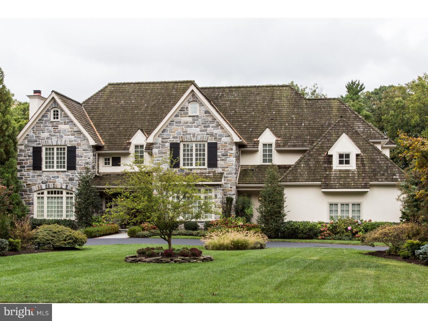 This quality construction home is beyond any builders dream!! The home is a stone-fronted jewel set in the verdant landscape of an old Main Line neighborhood, located in Radnor Twp. and next to Ardrossan Farm, the former home of celebrity heiress Hope Montgomery Scott. Built with loving hands by its owner's family this 5 Bedroom. 4 Bath, 2 Powder Room home is replete with elegant architectural details and offers three floors of exquisite living space. The open concept Kitchen offers top of the line, built-in appliances, custom solid wood cabinets, granite countertops, a large center Island with Breakfast Bar and a Butler's Pantry with wet bar. The light-filled Breakfast Nook has a tray ceiling and access to the spacious Great Room and to the slate and antique brick Patio and gorgeously landscaped yard. Fireplaces with Colonial mantles grace both the Living Room and the Great Room. The Library is trimmed in natural wood and offers a refuge from daily stress. The two Powder Rooms are on the main floor, one off the Foyer and one off the Mud Room. The Master Suite has a dressing area with matching His & Hers walk-in closets with built-in storage. The Master Bath has twin vanities, a walk-in glass and stone shower, a jetted tub flanked by windows and an enclosed toilet. The Lower Level could easily be an In-Law Suite as it boasts a full Bath, a Bedroom, a Family Room and an Exercise Room. Hand-picked specimen plantings are watered by drip irrigation while the yard has an automatic sprinkler system. The circular drive is flanked by lampposts and tipped by brick pavers. Even the chimney stacks have architectural brick designs. Oasis in backyard but close to the town of Wayne, major arteries and award winning Radnor Schools. Don't miss out on this Main Line gem!