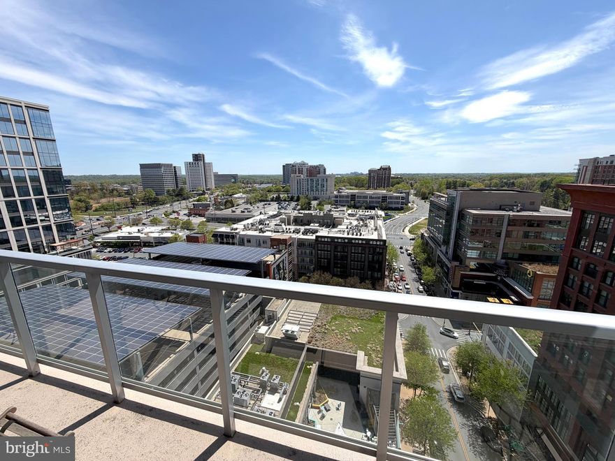 PRICE IMPROVEMENT! Million Dollar Views from your Urban Retreat in the Sky! Nestled high above the vibrant Pike & Rose community of North Bethesda, on the 16th floor, this exquisite two-bedroom, two-bathroom residence at 930 Rose offers stunning panoramic treetop views with in a luxurious urban lifestyle defined by comfort, elegance, and modern design. Built in 2018 and spanning approximately 1,231 square feet, this contemporary high-rise home features a thoughtfully designed open floor plan that seamlessly blends living, dining, and entertaining spaces, creating an ideal setting for both everyday living and sophisticated gatherings. From the moment you enter, engineered wood flooring flows throughout the residence, establishing a warm and inviting atmosphere enhanced by expansive floor to ceiling windows that bathe the interiors in natural light from every room all year long. This phenomenal residence has been impeccably maintained and feels like a brand new residence.

At the heart of this incredible home, the modern gourmet kitchen is designed to impress, showcasing a large center island with waterfall edges, perfect for casual dining and entertaining, premium cabinetry, and high-end stainless steel appliances including a gas range, built-in microwave, and a sleek dishwasher—making it a true culinary enthusiast’s dream. Designer pendant lighting provides a soothing atmosphere for enjoying morning coffee or lunch overlooking the horizon. The spacious living area transitions effortlessly to a private balcony, providing the perfect space to relax and enjoy the dynamic surroundings of this thriving neighborhood.

The luxurious primary suite offers a tranquil retreat complete with a generous walk-in closet customized with built ins and a spa-inspired bathroom featuring sleek and modern double vanity a stunning glass-enclosed walk-in shower with hand selected designer tile. The second bedroom is equally spacious and versatile, offering ample closet space and convenient access to a beautifully appointed second full bath with a nice sized bathtub, ensuring privacy and comfort for residents and guests alike.

This chic city residence conveys with 1 private garage parking space (#50) and 1 very large storage unit (42A)

Residents of 930 Rose enjoy an exceptional collection of amenities, including concierge service, a state-of-the-art fitness center, bike storage room, billiard room, welcoming lobby, secure storage, and a parking garage with assigned spaces, all supported by 24-hour security for complete peace of mind. Perfectly positioned just across the street from The White Flint Metro, premier shopping, acclaimed dining, and entertainment, this exceptional residence embodies the perfect blend of luxury, style, and convenience in one of North Bethesda’s most sought-after urban communities.
