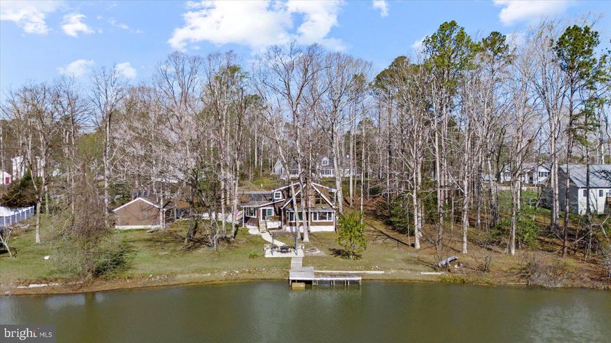 Rare Waterfront Sanctuary on Three Combined Lots — 288 Ft of Private Shoreline in Gated Lake Land'Or
Just 90 minutes from Washington, D.C., and strategically located between Richmond and Fredericksburg, this is the lakefront escape you've been looking for. Spanning 1.21 acres across three combined waterfront lots, this property delivers the space, privacy, and seclusion that serious lake buyers spend years trying to find.

The Home & Homestead
Boasting 2,175 sq. ft. of finished living space, the expansive 3-bedroom retreat offers a highly functional and thoughtful layout. It includes a massive primary suite, two full baths, one half bath, a scenic library, and a dedicated, climate-controlled home office with private exterior access (which easily serves as a 4th bedroom).

The property has been meticulously updated and lovingly maintained, with all major systems—windows, siding, roof, HVAC, and water heater—replaced in recent years ( 2018), offering turnkey peace of mind. Designed for the health-conscious buyer, the home features a Waterdrop reverse osmosis drinking system, a whole-house sediment filter, and an established organic lakeside garden.
Warm maple hardwood floors flow through the main level, complemented by a fireplace and a well-appointed kitchen with granite countertops, stainless steel appliances, and a gas stove. A backup propane heater ensures the home stays cozy in any season, while high-speed Xfinity internet makes remote work seamless.

Resort-Style Outdoor Living
Step outside and the property truly comes alive. Start your mornings with spectacular, uninterrupted east-facing sunrises over the water. A covered front deck, elevated second-story porch, pergola, and a 256 sq. ft. patio with a fire pit offer endless ways to entertain. An older private dock sits ready for your future waterfront upgrades, perfectly positioned next to a productive pear tree. With little light pollution, the backyard transforms into a stargazing haven every night. An oversized 672 sq. ft., 2-car detached garage easily houses your lake toys and weekend projects.

The Lake & Wildlife
This home sits on Lake Heritage—a quiet, motorboat-free gem within the Lake Land'Or community. Glide along your 288 feet of private shoreline in a kayak or paddleboard without a wake in sight, or drop a line to catch bluegill, crappie, and largemouth bass. The wildlife here is a daily ritual: blue herons stand sentinel, kingfishers dart across the surface, and ospreys regularly fold their wings to pound the water and pull up a fish.

Community Amenities & Peace of Mind
When motorboat action is desired, residents have access to the main 87-acre lake via community boat ramps just minutes away. Enjoy resort-style amenities including a gated entrance, pool, private beaches, a clubhouse, and tennis courts. Best of all? The property holds coveted FEMA Zone X status—meaning no flood insurance is required.

Three waterfront lots. Unmatched privacy. Turnkey living. This is the one you don't let pass.

🌟 Property Highlights at a Glance:
1.21 Acres & 288 Ft. Shoreline: 3 combined lots on quiet, wake-free Lake Heritage.
2,175 Sq. Ft. Layout: 3 bedrooms + dedicated office (easily serves as a 4th bed) + library.
Major Updates: Roof, HVAC, windows, siding, and water heater replaced  2018.
Wellness Features: Reverse osmosis water, sediment filter, & lake-irrigated organic garden.
Outdoor Entertaining: Multiple decks, patio, fire pit, private dock, and oversized 2-car garage.
No Flood Insurance: FEMA Zone X designation.
High-Speed Internet: Xfinity active; Fios expanding into the neighborhood.