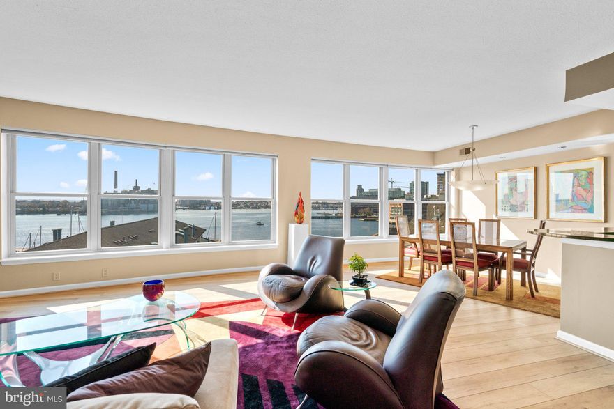 Welcome to waterfront luxury living in the heart of Fells Point! This 2-bedroom condominium, situated on a prime yet tranquil street, offers an open concept floor plan that exudes sophistication.

As you enter, the impressive ceramic tile entryway sets the tone for the elegance that unfolds within. The beautiful white kitchen is a showstopper, featuring brand-new cabinets and new stainless-steel appliances. The range hood, a focal point with its modern design and exquisite tile detailing, adds a touch of contemporary flair. The kitchen also boasts new multilevel granite countertops, providing ample space for barstool seating—a perfect spot for morning coffees or casual dining.
A wall of new windows on the water side offers breathtaking views of the harbor, filling the space with natural light and creating a seamless connection between indoors and the picturesque surroundings. The main living area and primary bedroom feature updated flooring, enhancing the overall allure of the condominium. Step outside onto the deck off the main living area, providing the perfect vantage point for enjoying the mesmerizing water views.

The primary bedroom is a retreat of tranquility with a recently updated ensuite bathroom. Both the bath and bedroom are adorned with crown molding, adding a touch of classic elegance. The ensuite bathroom boasts a double sink vanity and a large glass shower with tasteful tile accents.

Ownership grants access to a host of amenities in this sophisticated residence. Benefit from 24-hour front desk coverage, take a refreshing dip in the outdoor pool, and stay fit in the recently renovated exercise room. Community spaces offer a stylish retreat for gatherings and events.

Parking is a breeze with 2 dedicated garage spaces, ensuring convenience in the heart of Fells Point. Seize the opportunity to experience the epitome of waterfront living—schedule your visit today and make this spectacular condominium your new home!