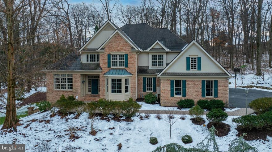 This elegant, inviting home features a timeless design for living and a peaceful, park-like setting on 1.68 acres with access to Rosenmiller Farm amenities of hiking trails, tennis courts, pond and more. From the moment you drive up to this 2 story Custom Brick home you will be impressed. The impressive interior showcases custom craftsmanship , striking architectural details, custom mill work, spacious and well thought-out floor plan with natural light throughout over 5000+ sq ft of living space, that has been meticulously updated  inside and out making this home move in ready. The first floor features all hardwood Brazilian cherry floors, a grand 2 story foyer,  dual stair cases, handsome 2 story great room with floor to ceiling windows, fireplace with custom tile surround, French doors opening to the rear patios, gardens and waterfall features, all seamlessly flowing into the well designed chefs kitchen with stunning granite counters, center island, breakfast bar, custom cabinetry, updated appliances a dining area with walls of windows and skylight. The first floor also offers a formal dining room  perfect for entertaining large gathering and access to a butler/bar, an additional  family room with vaulted ceilings and skylights off the kitchen area, and the first floor Primary suite  featuring  two walk in closets, a completed renovated primary bath with walk in shower, 2 separate sinks,  free standing tub with outside views to enjoy, tile floors and a separate water closet. The adjacent office/den has convenient private access from the primary suite as well as French doors to the foyer. Completing the first floor is a half bath on the first floor along with a large walk in laundry room with windows and storage, a hall of storage closets and entry to the fantastic 4-car heated garage with an additional half bath. The second floor showcases the home's aesthetics from balcony overlooks into the entire first floor, and offers secondary bedroom with an en suite bath and walk in closet, two additional large bedrooms with a shared bath providing but each bedroom with its own separate vanity and commode. Opposite the bedrooms, is a delightful office/music room with skylights, custom  cherry built-ins and inviting reading nook perfect for curling up with your favorite novel. The full, finished lower level provides another large family room with windows,  kitchenette, possible 5th bedroom, full bath, exercise room, storage and a flexible layout to suit your tastes.  The large work shop area is an added bonus, and includes double doors opening to the outside yard. The exterior grounds offer magnificent mature landscaping, updated brick walkways, patios and landscape lighting all in a very private setting embraced by mature trees. The large driveway with additional parking for guests is heated for your safety and ease.  The location of the home perfectly places I-83, Hospitals, Health care,  Schools, Colleges, Shopping, Golf Courses, Country Clubs, Parks  and more at your fingertips, and sits in York Suburban School District. A full list of the home's upgrades and amenities is available in the MLS or by request. This is just a wonderful home in a perfect setting and location. Don't miss it!