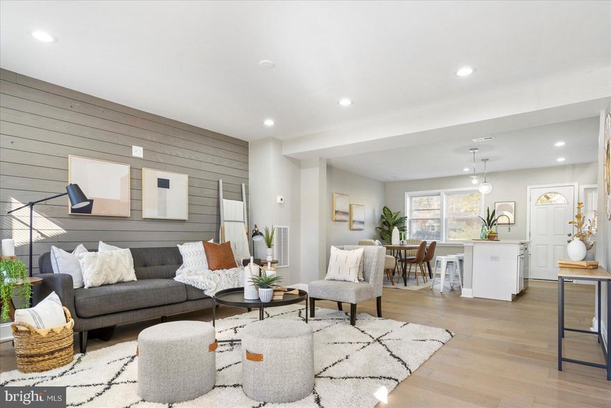 Beautifully renovated to create the open concept living new homeowners are seeking.  This 3BR/2BA  brick Townhome with a covered front porch is located in the quiet neighborhood of New Northwood.    Step inside to a crisp interior, and take a deep breath as you steep in all the glory of an open concept main floor. Tons of natural light throughout with beautiful flooring and a gorgeous wood plank feature wall in the living room, and that open view of the dining room and amazing open kitchen.  The kitchen offers plenty of upper and lower cabinets topped with a quartz countertop and subway tile backsplash, stainless steel appliances, and a deep stainless sink in the breakfast island offering seating and pendant lighting.  The freshly carpeted second floor boasts a large primary bedroom, two sizable secondary bedrooms, and a full bath with a stunning tiled tub surround. Next, the newly finished lower level features new carpeting throughout the entire space with room for everyone in the family, a laundry room, storage, a full bath with a uniquely tiled walk-in shower, and a walk-out to Bilco doors. From the kitchen step onto covered stairs and the fenced parking pad with room for entertaining.  This home is move-in ready with so much to offer new homeowners, and is located within close proximity to shopping, restaurants, and commuter routes.