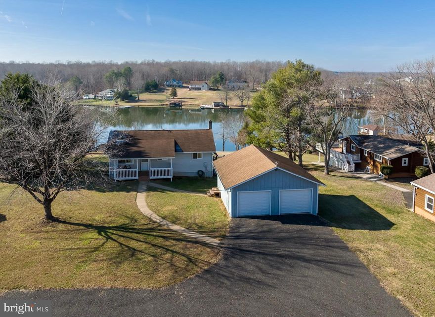 Discover your new lifestyle at this waterfront retreat with unforgettable views!  Located on the public side of Lake Anna, this lake home is waiting for your new memories to begin.  Kick off your weekend by starting with the gorgeous sunsets from your backyard or relax on the newly built boathouse (deep water 10ft) constructed with maintenance free PVC & composite decking, heavy duty electric boat lift, storage area and sun deck (boathouse built 2020).  Beautiful views and 100ft(+/-) of rip-rap shoreline.  This 4 bedroom, 2 full bath home offers 2,500+ square feet and comes fully furnished (3 bedroom septic).  Enjoy your morning cup of coffee from the lakeside Florida room or the screened porch.  The large backyard that overlooks the water invites your imagination for new outdoor living ideas and peaceful enjoyment.  Equipped with a 2-car detached garage that has a 50 amp RV hookup and a large enclosed pole barn with cement flooring and a lean-to that's perfect for storing cars, boats and water toys. High speed Xfinity Comcast internet.  The zero turn Cub Cadet mower conveys, lake floats, tubes, life jackets, kayak, SUP board and many other items convey.   Great lake location!  Less than a minute boat ride to the Cove restaurant and marina, and close proximity to Tim's at Lake Anna, Below Deck LKA, Moo-Thru ice cream, mini golf and much more!  What more could you ask for?  Come envision your new beginning while it's still available!