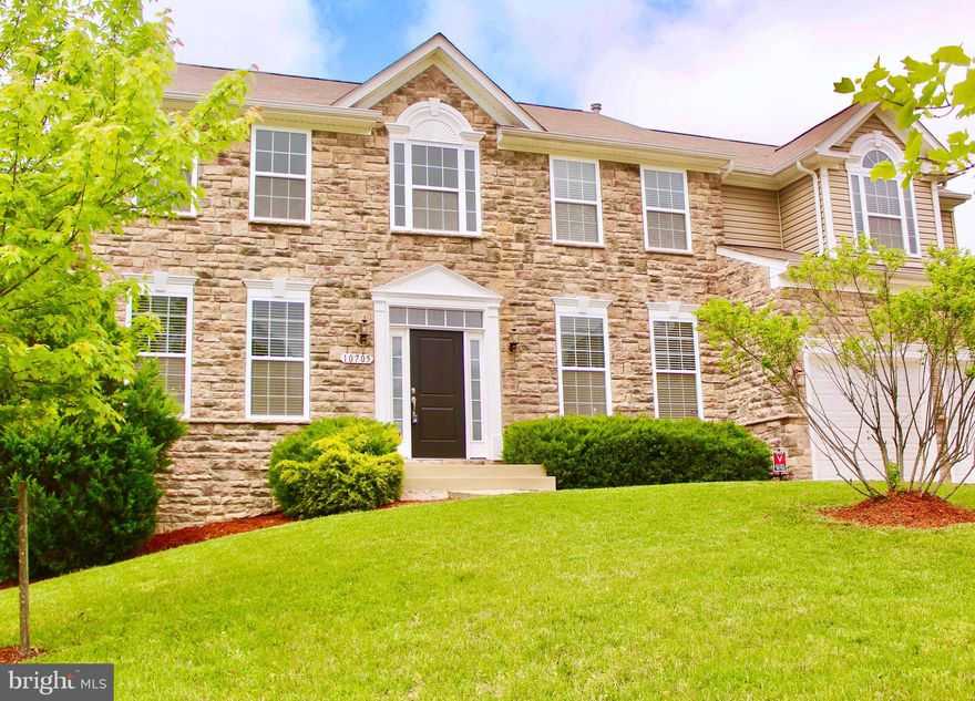 Exquisite custom colonial featuring over 4200 sf., of timeless elegance. Stunning stone front colonial with new carpet, and freshly painted.  The floor plan offers a circular flow perfect for entertaining formally inside or informally outside deck. Walk into your new grand foyer, to formal living and dining room and office/study   expansive gourmet kitchen with adjoining great room with a fireplace flanked by large windows. The kitchen features a double oven, center island with gas cooktop, and expansive deck off the kitchen to the lovely landscaped backyard. On the upper level, the stunning owner's suite is complete with vaulted ceiling, luxury spa-sized master bath with tub,  seated vanity area, walk-in closets, and dressing area. This master suite is fit for royalty with a lovely three-sided fireplace and sitting area.  The upper level also includes three additional cozy bedrooms all with walk-in closets.  The fully finished walkout basement with spacious recreation/media room and full bathroom.  The two rooms located in the basement has soundproof panels in the theater room and fifth bedroom/studio (great for streaming). Great Location located in the Timber Ridge subdivision close to Metro, Major Highways, Shopping, DC, VA, AAFB, National Harbor, MGM & so much more.