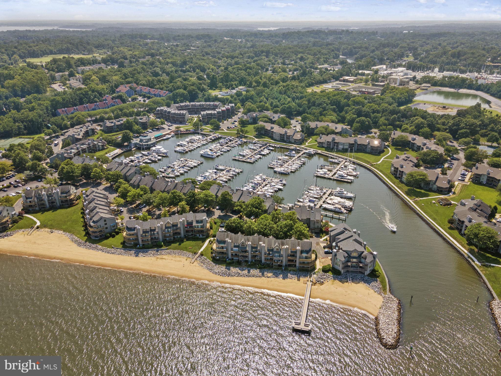Enjoy resort-like living at Chesapeake Harbour, a gated community filled with amenities and beautiful water views of the Chesapeake Bay! This desirable 2 bedroom, 2 bathroom ground-floor unit offers access to dual covered terraces, a wood-burning fireplace, and updates throughout. The kitchen features new countertops and a new refrigerator as well as recently updated sink, stove, dishwasher, and cabinets. The owner's suite provides its own terrace entrance plus a walk-in closet and en-suite bath with double-sink vanity. This community offers a marina with a waterfront restaurant, summertime Tiki bar, two pools - including one that is bayfront- plus tennis courts, a private beach, pier, storage for your canoe or kayak, and onsite security. Ideal location just three miles from Historic Annapolis, near commuter corridors to DC and Baltimore, and just 30 minutes from BWI airport. Come and enjoy the abundant amenities and the convenience of living in the waterfront community of Chesapeake Harbour!