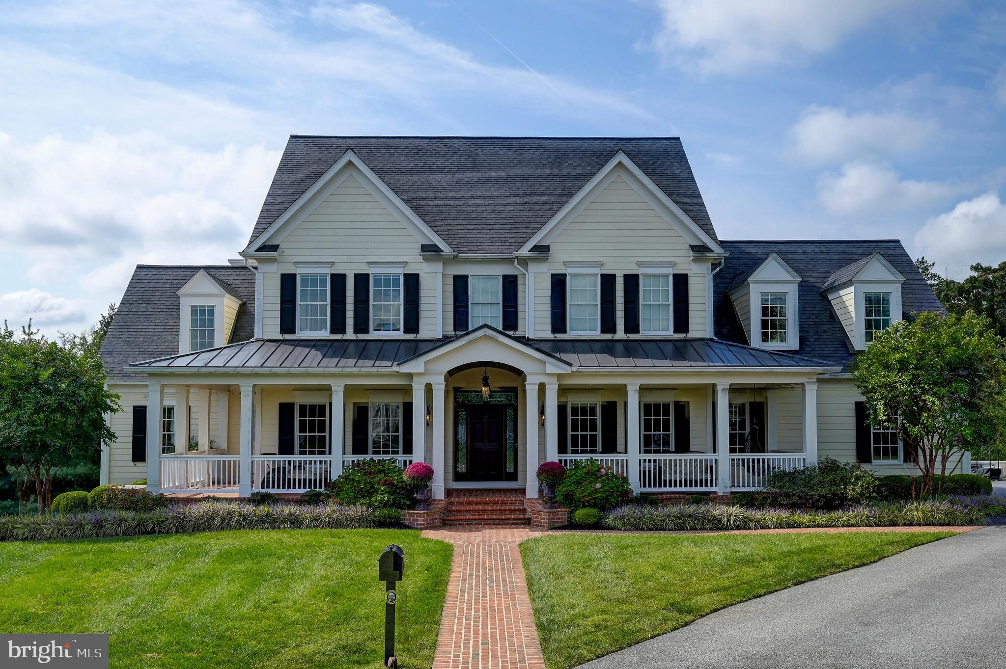 A magnificent GYC Group custom-built five-bedroom, four full and one half bath colonial with a wrap-around porch and three-car garage in the coveted and gated community of Ridge at Ruxton. Just some of the features that grace the over 5,300 SF of stylish living space include gleaming hardwood floors, custom built-ins, window seats, 9' ceilings, designer lighting, fine millwork, and coffered/trey ceilings. The main level boasts a gracious foyer that leads to the sun-filled study, the ideal spot for working from home. Adjacent formal dining room with breathtaking chandelier and butler's pantry, perfect for hosting a gathering of any size. The chef's kitchen with stainless Wolf gas oven/range, SubZero 48" built-in refrigerator, granite counters with an 8' island/breakfast bar, and dining area, is open to the spacious family room with a wood-burning/gas insert brick fireplace. The upper level includes a luxurious Primary Suite with custom closets, ample storage, and a spacious sitting room. Three additional large bedrooms with two full baths, bedroom level laundry with front loading washer and gas dryer. The lower level is fully finished and comes complete with a fully equipped theatre room with tiered seating, kitchenette with granite bar, fifth bedroom, full bath, great recreation room, plenty of storage, and walk-out. The exterior boasts professionally landscaped gardens, a screened-in porch with skylights, brick patio, and hot tub. Also includes a 3-zoned geothermal HVAC, fully-owned 13.08 kW solar system, backup generator, audio/video broadcast throughout, administered by a Control4 home control system, making this a smart, efficient and beautiful Ruxton home.