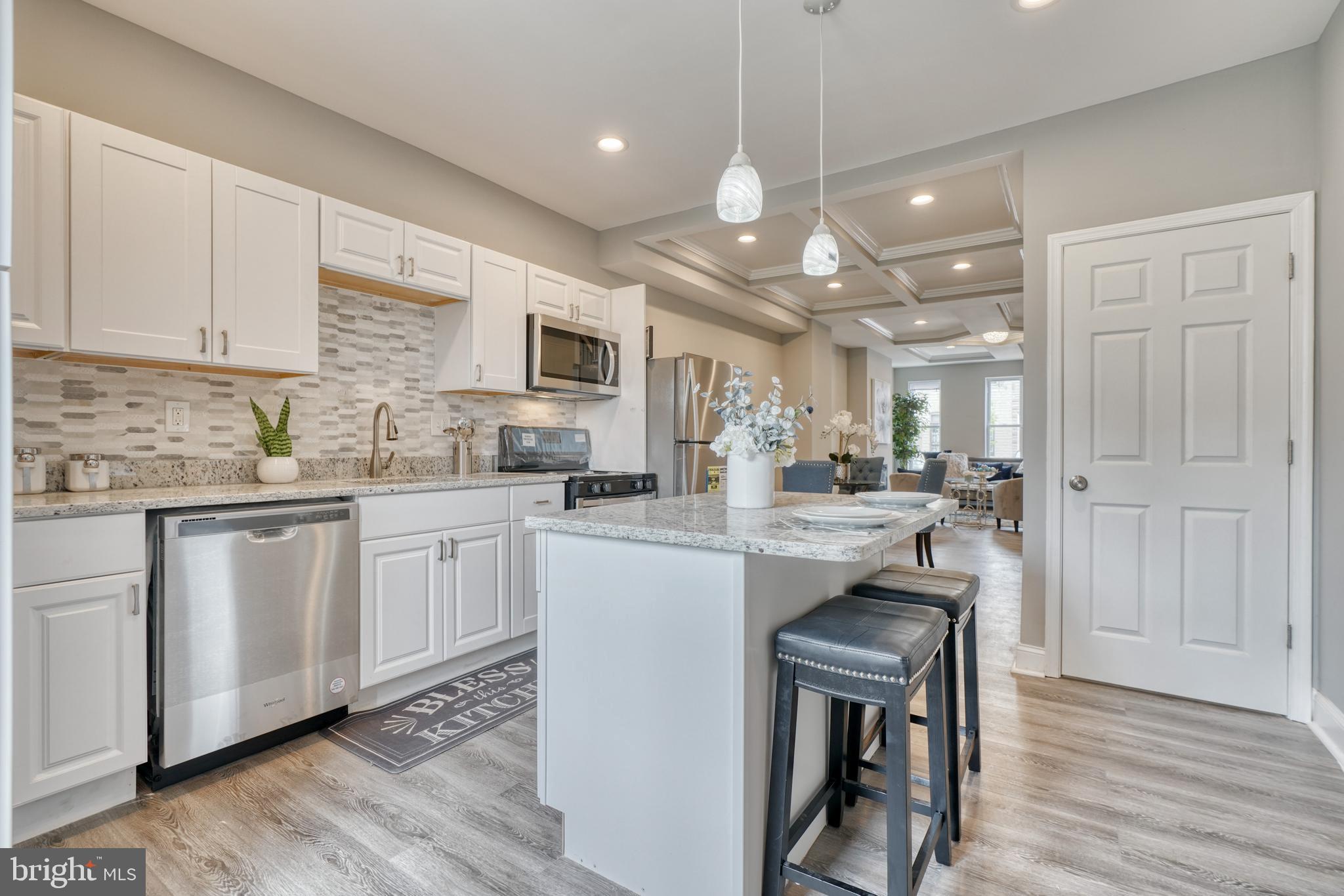 This beautiful home features 2 spacious bedrooms and 2.5 baths. Open floor plan with laminate flooring through out, custom lighting, gated back yard, designer eat-in kitchen with great cabinet space, stainless steal appliances, granite counter tops and island. Finished basement with room that could be used as a third bedroom, den or office space. Minutes away from Johns Hopkins.