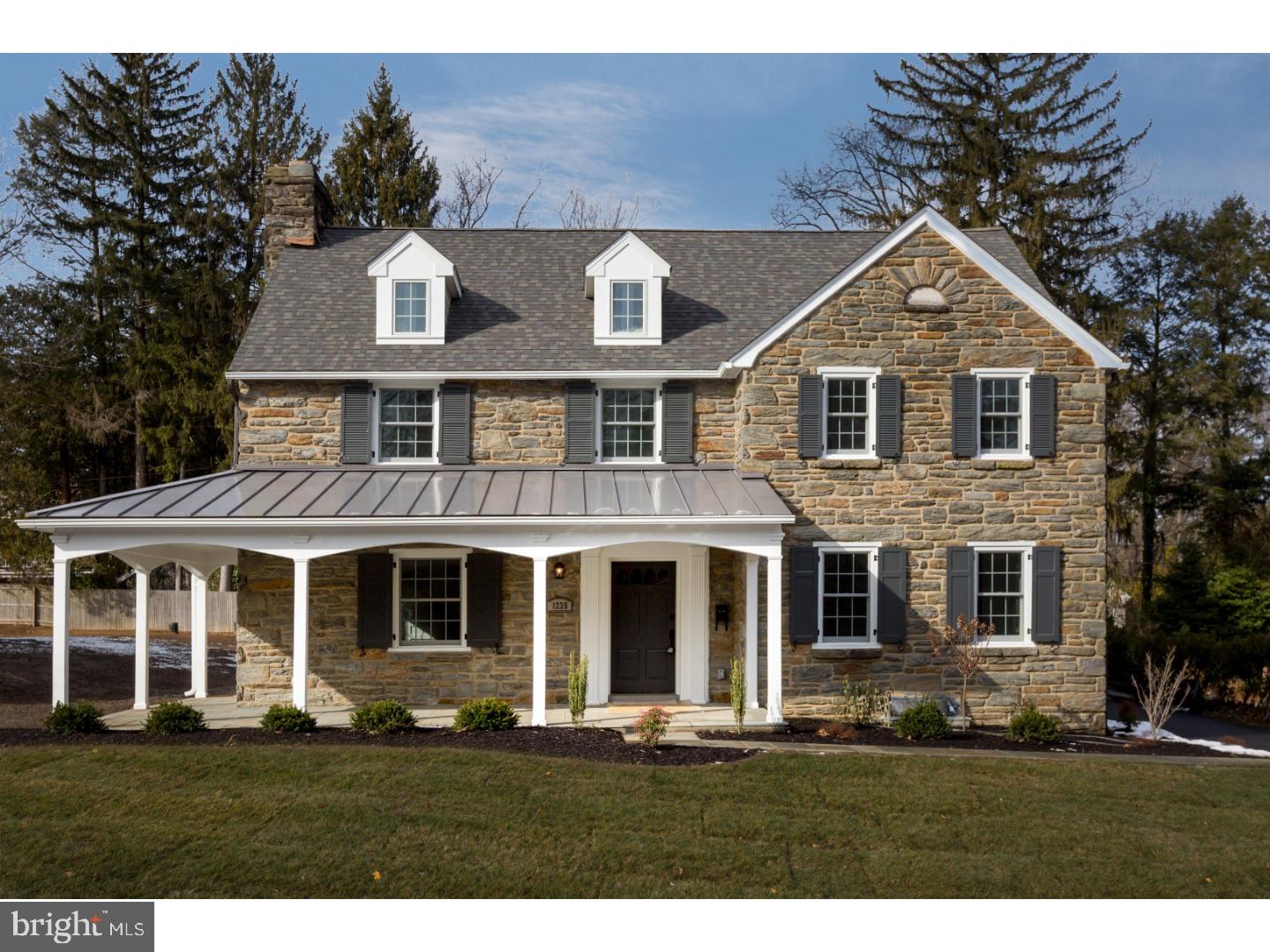 This spectacular two-story center hall colonial built by Sposato Home Builders will make the simple act of returning home feel instead like a thrilling arrival. What once was a modest, well-loved home, sitting on this fabulous property, is now transformed into a majestic newly constructed home with a gorgeous stone exterior and a charming wrap-around porch with metal roofing. The main level features an eat-in gourmet kitchen with stainless steel appliances, a large center island, Absolute black honed granite counter-tops, and subway tile back-splash. The main level has an open concept layout situated and styled to be perfect for entertaining. With sight-lines from the kitchen through to the sun-lit morning room and the inviting family room with a gas fireplace, the main level is an enchanting space for hosting. Also featured on the main level is a dining room with a charming bay window, living room complete with gas fireplace, large mudroom with built in storage, butler's pantry with a wine fridge, half bath, a two car garage, as well as access to a relaxing outdoor patio. Abundant natural light illuminates the exquisite hardwood floors used throughout the house. Elegant wainscoting and crown molding is used tastefully throughout the main level. The upper level is home to five incredible bedrooms and 4 bathrooms. Almost too marvelous for words, the master suite features coveted tray ceilings, a sitting area or office, as well as a spacious walk in closet. A huge arched window is the focal point of the master bath and serves as the backdrop for the stand-alone soaker tub. The master en suite also features his and hers sinks with granite counter tops, a private toilet, and a luxurious glass-enclosed shower. There are four additional spacious bedrooms upstairs; two of them have walk-in closets and their own connected full baths that feature a decorative tiled shower/tub, tiled flooring, and granite counter top sink area. The other two spacious bedrooms share a Jack-and-Jill bathroom with dual sinks, granite counter tops, and a shower/tub. A spacious laundry room with built-in storage and a utility sink is also located on the upper level. Finally, the lower level is a fully finished basement that boasts a bonus utility room and a half bath. This finely crafted home leaves nothing to be desired. Conveniently situated in Wynnewood. This beautiful home offers an easy commute to Center City, Public transportation, Parks, restaurants and shopping.