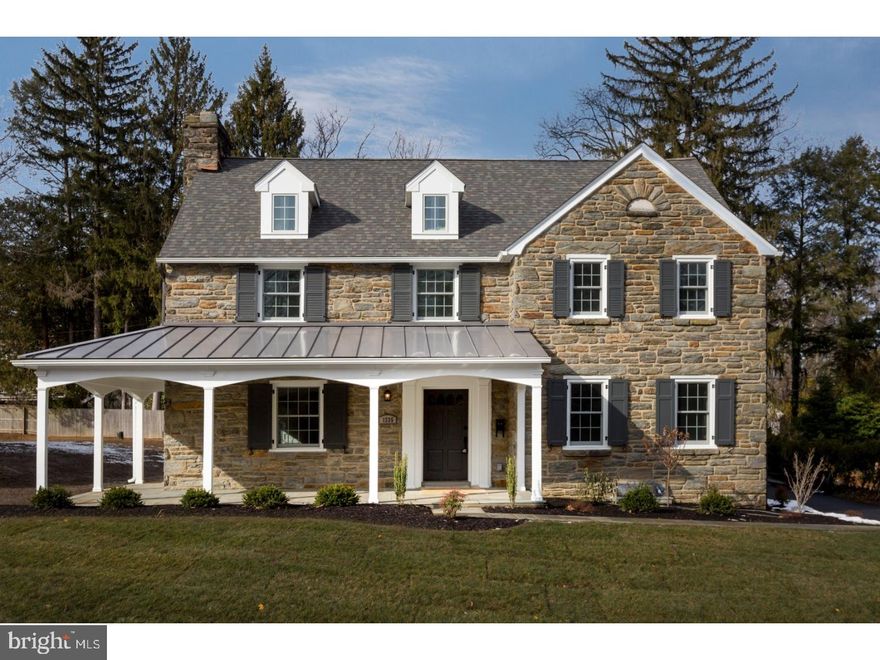 This spectacular two-story center hall colonial built by Sposato Home Builders will make the simple act of returning home feel instead like a thrilling arrival. What once was a modest, well-loved home, sitting on this fabulous property, is now transformed into a majestic newly constructed home with a gorgeous stone exterior and a charming wrap-around porch with metal roofing. The main level features an eat-in gourmet kitchen with stainless steel appliances, a large center island, Absolute black honed granite counter-tops, and subway tile back-splash. The main level has an open concept layout situated and styled to be perfect for entertaining. With sight-lines from the kitchen through to the sun-lit morning room and the inviting family room with a gas fireplace, the main level is an enchanting space for hosting. Also featured on the main level is a dining room with a charming bay window, living room complete with gas fireplace, large mudroom with built in storage, butler's pantry with a wine fridge, half bath, a two car garage, as well as access to a relaxing outdoor patio. Abundant natural light illuminates the exquisite hardwood floors used throughout the house. Elegant wainscoting and crown molding is used tastefully throughout the main level. The upper level is home to five incredible bedrooms and 4 bathrooms. Almost too marvelous for words, the master suite features coveted tray ceilings, a sitting area or office, as well as a spacious walk in closet. A huge arched window is the focal point of the master bath and serves as the backdrop for the stand-alone soaker tub.  The master en suite also features his and hers sinks with granite counter tops, a private toilet, and a luxurious glass-enclosed shower. There are four additional spacious bedrooms upstairs; two of them have walk-in closets and their own connected full baths that feature a decorative tiled shower/tub, tiled flooring, and granite counter top sink area. The other two spacious bedrooms share a Jack-and-Jill bathroom with dual sinks, granite counter tops, and a shower/tub. A spacious laundry room with built-in storage and a utility sink is also located on the upper level. Finally, the lower level is a fully finished basement that boasts a bonus utility room and a half bath. This finely crafted home leaves nothing to be desired. Conveniently situated in Wynnewood.  This beautiful home offers an easy commute to Center City, Public transportation, Parks, restaurants and shopping.