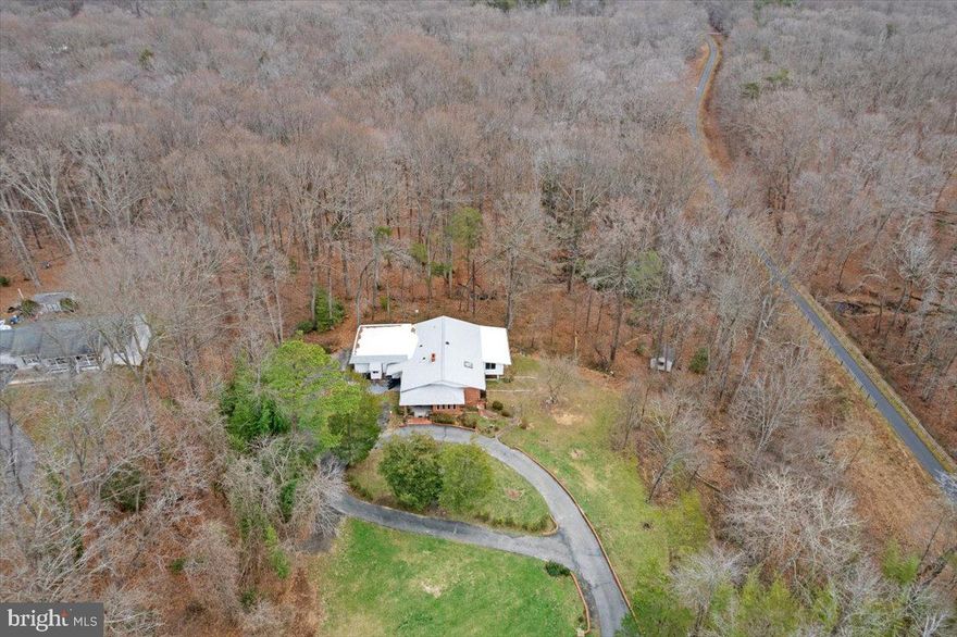LOCATION, LOCATION, LOCATION!
NO HOA

Prepare to be amazed by this sprawling 4.78-acre oasis - a true masterpiece of multi-family living! Tucked away in a tranquil, private setting, this property is just waiting for its perfect match. The location is simply unbeatable, with easy access to the Pentagon, National Harbor, and Andrews Air Force Base. And, with NAS Patuxent River only 38 miles away, you'll have access to all the privacy, parks, shopping, and fun you could possibly dream of. From the moment you set foot on this property, you'll be swept away by the breathtaking panoramic views. With seven bedrooms, five bathrooms, and a two-car garage, there's ample space for even the largest of families. And, the open floor plan is perfect for entertaining guests. The primary bedroom is simply divine, with wooden flooring, a walk-in closet, and a balcony showcasing stunning scenic views. The living room is equally impressive, boasting hardwood flooring, a cozy fireplace, and tons of natural light. And let's not forget the kitchen, featuring wooden cabinets,  quartzite countertops, and double sinks. Plus, there are plenty of extra amenities, including two laundry rooms, a gym/yoga studio,  basement with three bedrooms and two full baths, two offices, a studio apartment with a separate entrance above the garage, a family room, a den, a sunroom, and even a Japanese tea room - truly unbelievable! And, the outdoor space is just as impressive, with a front porch, circular driveway, and parking for eight or more cars. The backyard is perfect for outdoor fun, with 20 full-grown azaleas and a seasonal stream that abuts the Indian Head Rail Trail. This exceptional single-family home offers the perfect balance between privacy and accessibility, and is located near all the best grocery stores, restaurants, gyms, and parks. This is the opportunity of a lifetime - don't let it slip away! Contact us today to schedule a showing, and let our listing office help you turn your dream home into a reality.