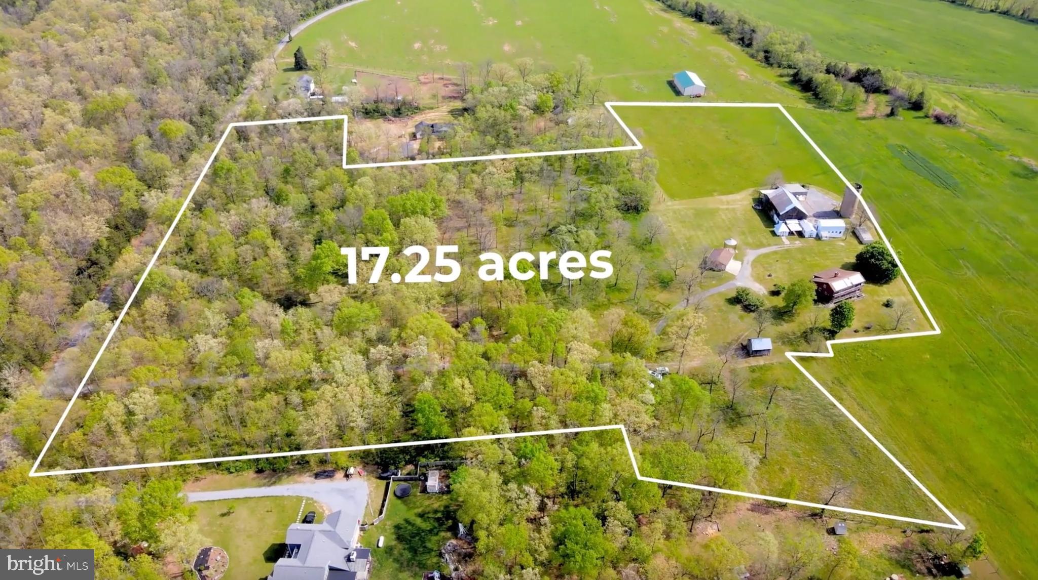 Imagine coming home down a long private gravel driveway through the front wooded area leading into this 17.25 Acre farm with log cabin and outbuildings! This farm features a two bedroom, a bonus second floor overlook, and two full bathroom log home, with solar panels on the roof with power bank that helps heat and cool the 2,600 SQFT above grade finished log home. with an unfinished, wood stove heated, partial sunlight basement of 1,394 SQFT, that has interior stairs down from the kitchen and exterior walk-up stairs to the back yard. This property was once a dairy farm with more acreage than the current 17.25 Acres. There are multiple usable out-buildings! There is a huge barn with a main level milking area with concrete floors, as well as a floored upper-level barn area with a hay loft. Behind the barn is an attached lean-to run-in shed. There is a large open pole barn to the side with concrete yard area. Other buildings include a large wood stove heated shop, with pull-down stairs to the floored upper storage area with a hay door. There is also a roofless silo that could be converted to a tiny home, a storage area, or back to a silo. Around the front of the barn is a separate dairy parlor with concrete floors and block walls. There is an open pole barn carport with a dirt floor between the milk parlor and the 12 Ft x 12 Ft concrete block tool shed. There is a corn crib, and a separate long run-in pole barn last used as chicken coop. Check out the modern two-car detached garage with two door automatic openers, additional storage, plus a separate lockable side door. There is a usable old one car wooden garage with a concrete floor. Now let us talk about the amazing, energy efficient log home with full unfinished, partial daylight basement! The entry door leads to a separate foyer/mud room with a coat closet, that has an entry door into the main level of this home which features log interior walls, spacious family room, with a bay window looking out to the porch, a re-circulating Finnish style woodstove insert into the brick corner fireplace with mantel, cathedral wood ceilings, and sky lights with an open floor plan concept with stairs to the upper level between the family room and the dining room. The dining room with a breakfast bar between the separate dining room and large kitchen! This large country kitchen has so much counter space, real wood soft close cabinets, a double sink that looks out to the yard, a cooktop, a built-in oven, a built-in microwave, and a dishwasher, plus a door out to the lower balcony! There is also a main level primary bedroom with beamed ceiling, carpeted floor and a sliding glass door to the lower balcony, the attached bathroom, has a walk-in shower, toilet and sink with adjacent door to the separate laundry room with hook- ups. The wooden stairs lead to the upper-level rooms. There is a second-level room that is carpeted, overlooks the dining room below and sliding glass doors out to the upper balcony. This second-floor overlook could be used as a recreation room, an office, a playroom, or a bedroom. There are numerous options to choose from with how to use this space! Down the hallway is the second story full bathroom with tub shower combo, and skylight! The second-floor carpeted bedroom is 17.2 Ft x 16.0 Ft and has a sliding glass door out to the upper-level balcony! This home has so much to offer! This farm has well and septic with no water and sewer bills! Electric bills are low because of the solar panels with power bank and the special re-circulating Finnish wood stove in-cert in the family room fireplace. The outbuildings and barn could be purposed for whatever your needs are or will be in the future. Call your favorite real estate agent to book a showing appointment to come experience this farm in person; Perhaps this could be the start of your new story and legacy.