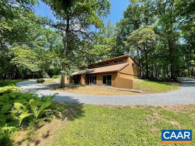 Live comfortably, earn income, work from home! Tucked away on just over 4 private acres in Albemarle, this unique contemporary duplex offers flexibility, function, and incredible value. Live in one side and rent out the other, two living spaces offers a great opportunity for extended family or rental income?the layout invites endless possibilities. The main living space features an open floorplan with an eat-in kitchen, a main-level bedroom and huge walk-in closet. Upstairs, you'll find a flexible loft area, an additional bedroom and bath with skylights, and convenient second-floor laundry. Sliding doors open to patio with wooded views and are accessible from living room and main floor bedroom. Recent upgrades includes a roof (ess than 10 years), brand new mini-splits, water treatment system, fresh interior paint, and new flooring on main level. With TONS of parking and privacy galore, this property blends contemporary design with versatile living under 10 miles to Hollymead Town Center, NGIC and area amenities.,Fireplace in Living Room
