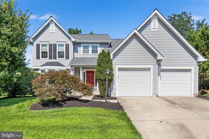 Nestled in the charming subdivision of Hunters Run, this stunning Colonial-style home offers a perfect blend of comfort and elegance. Built in 1992, this residence boasts a generous 3,192 square feet of thoughtfully designed living space.  The house has a new roof, new vinyl siding and windows. Step inside to discover a warm and inviting atmosphere, highlighted by wood flooring throughout the main level and upstairs as well. The heart of the home is the spacious eat-in kitchen, complete with a country-style design, an island that houses the gas range, and ample table space for casual meals. Equipped with new refrigerator, new dishwasher, new microwave and new beverage fridge.  The laundry/mud room is conveniently located off of the attached two car garage. The main level also features a cozy living area with a charming wood burning  fireplace, creating a perfect spot for unwinding after a long day. Large bay windows allow natural light to flood the space,  this area also offers a wet bar.  A convenient laundry chute into the mud room with washer and dryer adds to the home's functionality. This residence offers four generous sized bedrooms, providing plenty of space for everyone. The master suite with vaulted ceilings, featuring a luxurious  remodeled bathroom with both a walk-in shower, a soaking tub and a double vanity.   The Primary bedroom also offers a large walk in closet and a split system for added comfort. The hall bath has also been remodeled. The finished basement, complete with walkout stairs, offers additional living space that can be tailored to your needs—whether it’s a game room, home office, or gym. There is a wet bar in the lower level with sink, refrigerator and dishwasher. There is also a full bath with walk  in shower on the lower level.  Outside, the property features a lovely deck, perfect for enjoying morning coffee or evening gatherings. The attached front-entry two car garage provides convenient parking, PLUS EV Charger LEVEL 2-Tesla Charger in the garage,  complemented by a concrete driveway that accommodates additional vehicles. Set on a 0.21-acre lot, this home offers a peaceful retreat while being conveniently located near amenities and the NCR trail.  The property backs up to level open space.