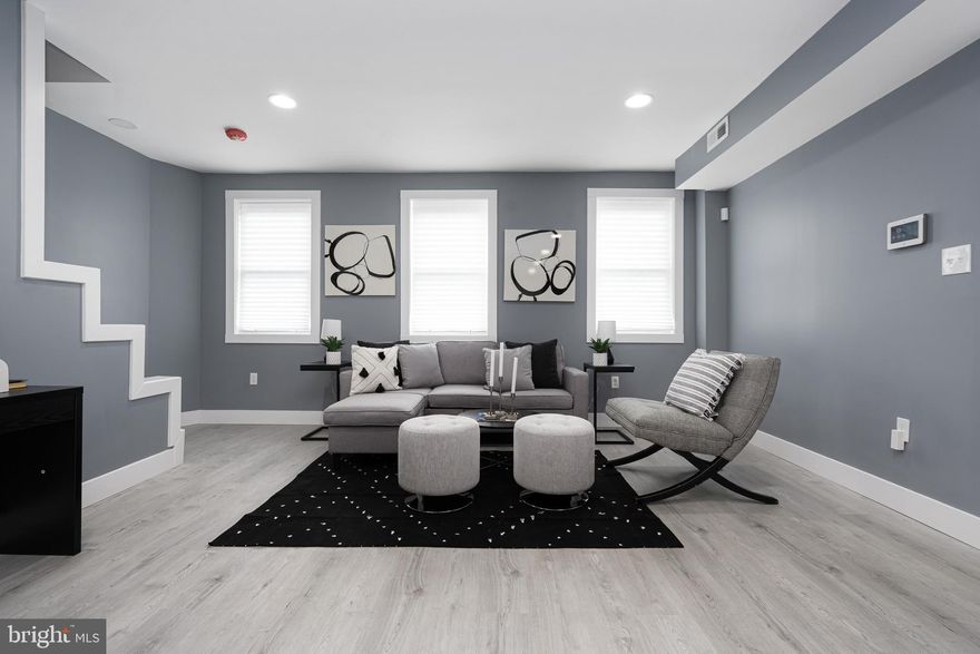 Welcome home to this beautifully renovated end-of-row townhouse in Baltimore City! Step inside and be greeted by an inviting living room featuring new LVP floors, setting the stage for modern living at its finest.The open-concept layout seamlessly connects the living room to the updated and spacious kitchen, which boasts an abundance of cabinets, quartz countertops, stainless steel appliances, and a stylish tile backsplash. A large island with waterfall countertop and extra seating provides the perfect space for casual dining or entertaining guests.The lower level features the primary bedroom, a luxurious and spacious retreat offering ample closet space and an ensuite bathroom with a stall shower, providing the ultimate in comfort and convenience.Upstairs, you'll find two additional bedrooms, each bathed in natural light and offering generous closet space, along with a full bath shared in the hallway—ideal for family or guests.Outside, the front porch invites you to relax with a cup of coffee while watching the world go by, while the backyard provides the perfect setting for hosting summer BBQs and outdoor gatherings. The dead end street and off street parking spot make for easy parking for you and all your guests! With its thoughtful design, modern finishes, and convenient location, this newly renovated townhouse offers the perfect blend of style and comfort—don't miss your opportunity to make it yours!