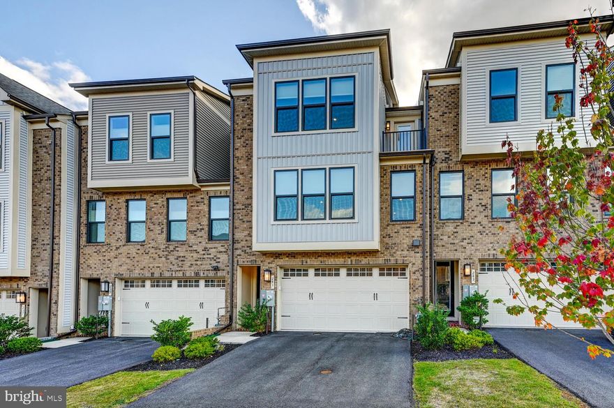 Welcome to the Woodley Park model, built in 2023, perfectly situated in the highly desirable Hunt Valley community. Perched above Hunt Valley Towne Centre, this home offers convenient access to top-rated schools, downtown, major highways, and BWI Airport. The main living level showcases an open-concept design with a spacious great room, dining area, and a chef’s dream kitchen—complete with an island, cooktop, and wall oven—ideal for cooking enthusiasts or influencers. A convenient half bath adds function, while the kitchen and dining area extend seamlessly to a private outdoor retreat with an exterior fireplace. Upstairs, you’ll find three bedrooms and two full baths, including a luxurious primary suite with a peaceful wooded backdrop. The entry level features the main entrance, a recreation room, another half bath, and an attached garage, providing comfort and convenience throughout every level of the home.