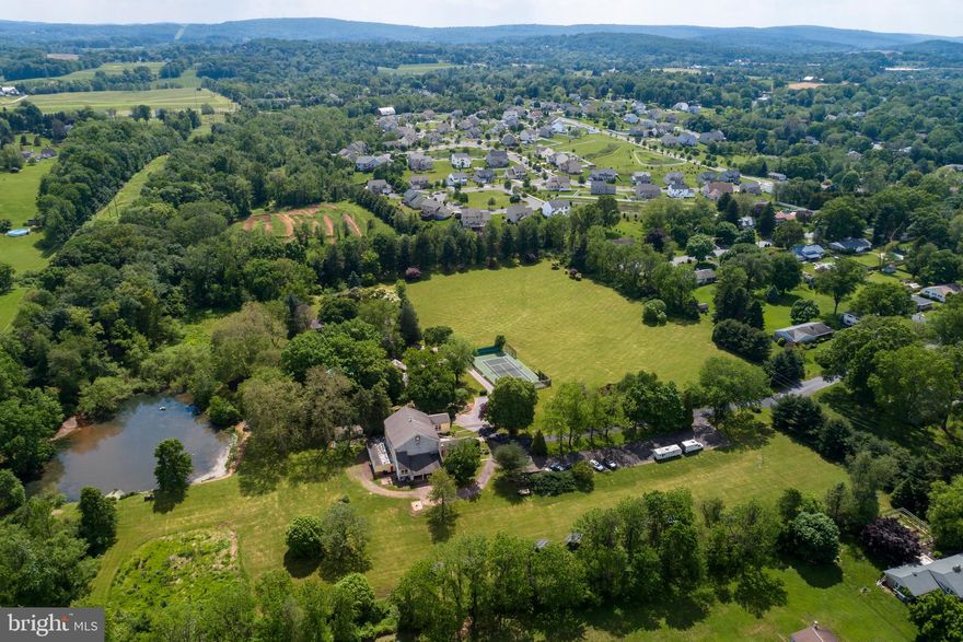 Your 31.5 Acre OASIS Away From Everything!. Luxury Listing & Once In A Lifetime Opportunity.  PRICED To SELL with the price per square foot AND price per acre being competitive at HALF the price of nearby comparable properties.  Majestic & Peaceful & Quiet 31.5 Acre Property Containing 3 Major Structures: 1 Extra Spacious Main Home, 1 Large Guest House, 1 Massive Office Building (Amazing Converted Barn) w/Parking Lot, plus 1 Apartment, 6 Garage Parking Bay Spaces, Inground Pool & Sauna Building, Tennis Court, Many Large Green Spaces, Professional Landscaping & Plantings, Garden Spots, Walking Paths, Wooded Areas, Large natural Pond, Large Shed, Fun Motorcross Race Course, Solar Panel Field, and more. *Perfect for Horse Lovers and Farmers and Farm Animal Lovers too--Some stable still in-place in the Converted Barn.*  In total, there is approximately 18,000 Interior Square Feet. One of the LARGEST ESTATES AVAILABLE in the Region. **Plenty of Spaces to run your business/office from The Converted Barn and also hold school at home.*** Easy Maintenance for everything because of the many Modern Updates. The Main Residence is a 1734 Chester County Stone Farmhouse with 6 Bedrooms & 5.5 Bathrooms & 4,200 Square Feet. This Home is FILLED with Historic Details along with Today's Modern Amenities & High-End Finishes. You will appreciate original datail & woodwork & plasterwork, hardware, built-in cabinetry, deep windowsills, and original solid wood flooring. Large covered porch, foyer with slate flooring, a formal living room with fireplace, formal dining room, powder room, and a cozy study featuring original wide plank flooring, a wonderful historic walk-in fireplace, and a built-in wet bar. The country-farmhouse style kitchen is enormous with new cabinets & countertops, upgraded appliances, large island, and a dining area with large windows & amazing scenic views of the estate. TWO Staircases. The upper floors contain a Master Bedroom Suite with 2 Full Bathrooms, plenty of closet space including walk-in closets, stone fireplace. There are 4 more large bedrooms, more closet spaces, 3 more Bathrooms, and a formal Laundry Room. You can take a walk to the Updated 3-story Stone Guest House which has 2 bedrooms, 1 bath, large screen porch, and 2,000 square feet. The Converted Barn is a Formal Office Building with 8,000 Square Feet, soaring 35-Foot Ceilings with Exposed Beams, Newer Roof, zoning variance for Commercial use, 2 Bathrooms, and definitely Large enough to run you own business/office without needing to leave home. Also, located below the offices, the building also contains horse stalls, a 1 Bedroom-1 Bath apartment, 6 garage bay parking spaces, gym rooms, more work areas and more parking areas. There is also a Solar Panel System the generates electricity that "zero's out" the electric bill for the Office Building. The Sauna is located near the in-ground pool and has seating for 8-10 people. If you wish to Sub-Divide the Property, the current Owner has approved 4 acre Sub Division Plans, which will not interfere with the current Main Residence Areas, and you may also choose to sell a portion of the 31.5 Acres otherwise. You may also want to lease some of the buildings to generate income while residing in the Main House. This Property is conveniently located 40 minutes from Center City Philadelphia, 1 Hour from Princeton, 2 Hours to NYC by car. Travel faster and easier with the train lines too. 3 Separate Land Parcels. In total there is approximately 18,000 Interior Square Feet, 9 Bedrooms, 7 Full Bathrooms, and 3 Powder Rooms. You need to see this amazing property in-person before looking at other homes so you do not miss this rare opportunity.