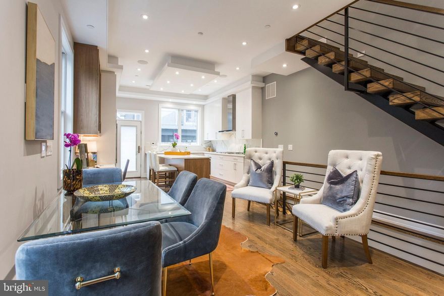 Introducing 1409 Pemberton Street. Refined LUXURY defines this CUSTOM-BUILT 4 BEDROOM, 4 BATH, 2 CAR GARAGE, new construction townhome offering the finest craftsmanship and attention to detail. 10 YEAR TAX ABATEMENT. MASTER SUITE ON THE 2nd floor! Situated in the Graduate Hospital neighborhood, this incredible home boasts 3,300 square feet of urban living and appointed with state-of-the-art finishes, gorgeous fixtures and contemporary amenities, all selected for the discerning eye. Its exterior was built with premium materials; brick, corrugated metal panels and Limestone and offers three sides of expansive windows to allow natural light to filter into the interior. An attractive covered entryway with a 4-panel glass door, wood slated walls, Ring doorbell and tiled floor protects against inclement weather while creating a welcoming vibe. Once inside, a subtly patterned tiled foyer welcomes you into the interior and provides access to the GARAGE with a premium CAR LIFT designed for 2 small SUVs. Step into the MAIN living area to discover an exquisite GOURMET Kitchen and Dining area with 10 foot ceilings, Oak stained flooring, floating staircase, coat closet and two walls of windows for natural light with access to a back patio highlighted by a cedar planked privacy fence, ideal for entertaining. The professionally designed CHEFS KITCHEN showcases a blend of White and Walnut custom-built cabinetry, WOLF, SUB ZERO AND ASKO appliance suite with cooktop, stainless floating hood, double wall oven, under counter microwave, an island with bar seating, Built in desk, Carrara-style Quartz counters and backsplash, soffit & under cabinet LED accent lighting as well as speakers throughout. The entire LOWER level creates an impressive entertainment space for a home theater with its SURROUND SOUND SYSTEM, HEATED TILED FLOORS, wet bar with wine fridge and a full Bath plus storage. Its SECOND level contains the Master Suite and a second Bedroom with a walk-through custom closet with built in drawers, open shelving and frosted glass doors concealing the hanging wardrobe. Through the closet, a luxurious Master Bath awaits with a double vanity, quartz countertops, heated porcelain floor tiles and a walk-in shower with multiple showerheads and a glass enclosure. A second Bedroom shares this floor complete with an en suite full Bath. Upstairs, the THIRD level hosts Two large Bedrooms, a shared full Bath and Laundry Room complete with LG Steam Front loading washer and dryer, Quartz counter for folding clothes, a sink and upper cabinetry. Ascend to the pilot house where a wet bar with wine fridge is incorporated for serving cocktails while enjoying the sweeping skyline views and sunsets from the MODERN ROOFTOP DECK WITH OUTDOOR AUDIO and custom fabricated privacy railing, creating a truly impressive outdoor experience. Complete WITH WHOLE HOUSE AUDIO WITH KEYPADS throughout, 6 OUTDOOR CAMERA SYSTEM, NEST thermostats, 2 HVAC units with 4 zones, Epoxy coated garage floor, HEATED GARAGE, LED lights; this stunning three story residence epitomizes luxury! Licensed agent is affiliated with McG Investments I, LLC.  This townhome was built with the highest of standards.  Enjoy city living just steps away from ultimate conveniences with local dining, shops, transit and performing arts venues!