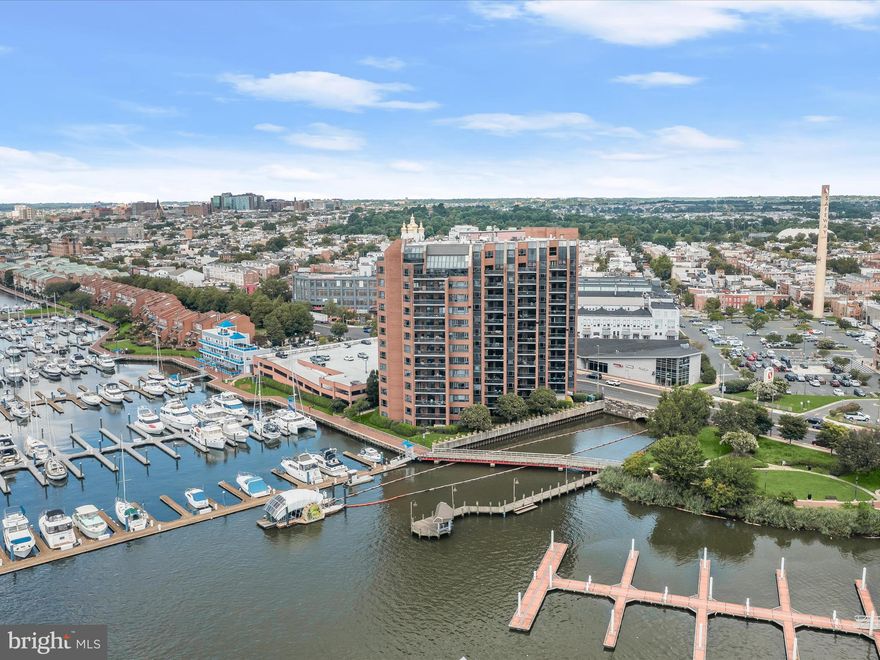 Waterfront living with unparalleled views awaits you at 2515 Boston Street #603, located in the prestigious Anchorage Tower of Canton. The Constellation model features two en-suite bedrooms and boasts a range of premium updates, including custom kitchen cabinetry, Pella sliding doors, updated HVAC, luxurious tile flooring, custom blinds, and window tinting. With dedicated parking spots and a separate storage unit, this residence is designed for both comfort and convenience. As you enter, the open floor plan immediately draws your eye to the breathtaking water views. The dining area, enhanced with classic moldings, flows seamlessly into the living room, where custom built-ins and access to a sprawling balcony invite you to relax and entertain. The chef’s kitchen, complete with quartz countertops and ample cabinetry, also offers balcony access, making it a perfect space for culinary creations and gatherings. The primary bedroom features an en-suite bath, a laundry area, and three closets, ensuring ample storage and privacy. The second en-suite bedroom also provides balcony access, offering guests a private retreat. A private office and a powder room complete this stunning home. Located in the vibrant Canton & Fells Point neighborhoods, you're just steps away from shops, restaurants, and nightlife. With one of the highest walkability scores in the city, urban living doesn't get better than this. Unwind on your private balcony, where breathtaking sunsets provide the perfect backdrop to your day. Anchorage Tower offers a secure living environment with a front desk attendant, secure garage, dedicated parking spots, and visitor parking ensuring optimal convenience in their waterfront oasis.  Some photos have been virtually staged