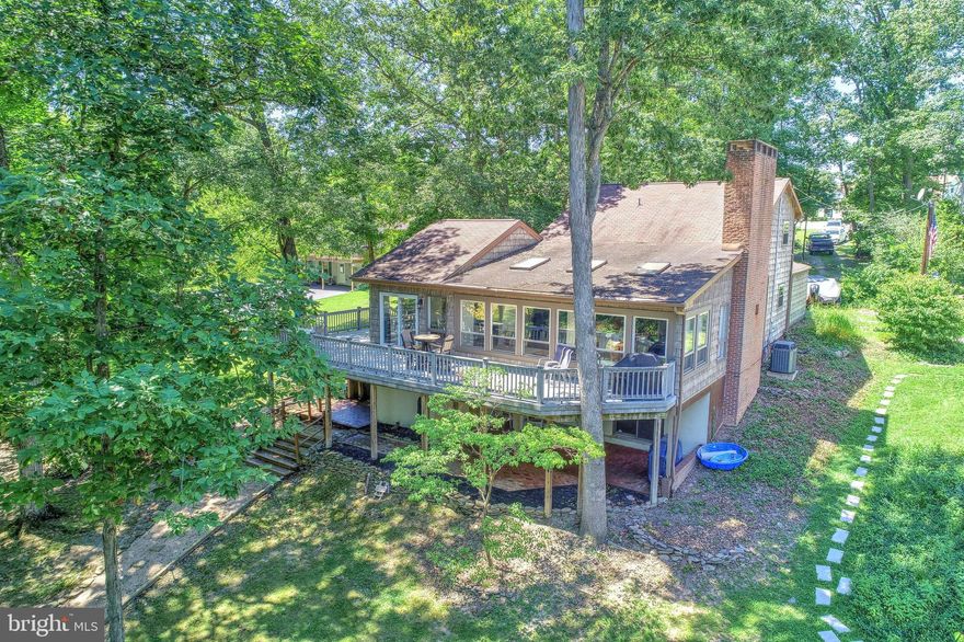 Experience the serenity of Lake Front living in this fantastic home in Lake Meade. The great room has beautiful hardwood flooring, a fireplace and is a generous size to entertain family and friends. The sunroom is bright and cheery with skylights and lots of natural light. The kitchen has a huge pantry, a sweet breakfast nook and all the appliances convey. The kitchen area is adjacent to an incredibly huge wraparound deck to enjoy the lovely lake views and the peacefulness you will find as you overlook the water.  When you re coming off a day of boating, fishing or swimming off your own dock, you will appreciate the convenience of walking into the lower level with a full bath and a family room. The family room boasts a wet bar and a fireplace, and has plenty of room for a pool table to continue the lake living fun. Outside living awaits you on this generous size lot that offers shade, or all the sun you want, lake side with very own dock. Swim, fish, kayak or hop in your boat and go enjoy wake boarding, water sports or a sunset cruise around the Lake. You will not lack areas for storage with a large storage room in the lower level, a tackle room and an over sized two garage. Beautiful sunsets and Serenity are waiting for you in this Lake front home in Lake Meade. Come enjoy the lifestyle of lake living today!Our Lake is manmade consisting of 300 acres and 5.84 miles of shoreline. Power boats, kayaks, canoes, sailboats and pontoon boats share the Lake. (Some restrictions apply) The Lake offers fun from tubing, water sports, and fishing. We are a private community gated community. Our gate is staffed 24 hours each day. Visitors and guest must register. The recreations activities include the swimming pool with lifeguards and a giant slide with two curves, zero entry with a mushroom fountain depth to 3 feet. Diving is 12 feet deep with two diving boards. Main rectangular pool is 50 x 82 with depths of 4 to 5 feet deep. There is also a bath house and a snack shack. Lake Meade has 10 water front access with boat docks, playground equipment and picnic places. There are 2 basketball courts and a tennis court. The sports complex offers ball field, sand volley ball courts, soccer fields, playground equipment for small children and a picnic pavilion. The marina complex features Macs pizzeria an informal eatery with outdoor deck and summer fun. There are two boat launches, limited boat services available. Our 4th of July celebration is culminated spectacular over the water firework display. Lake Meade Fire and Rescue is conveniently located in our community. Lake Meade Municipality provides public water and sewer.