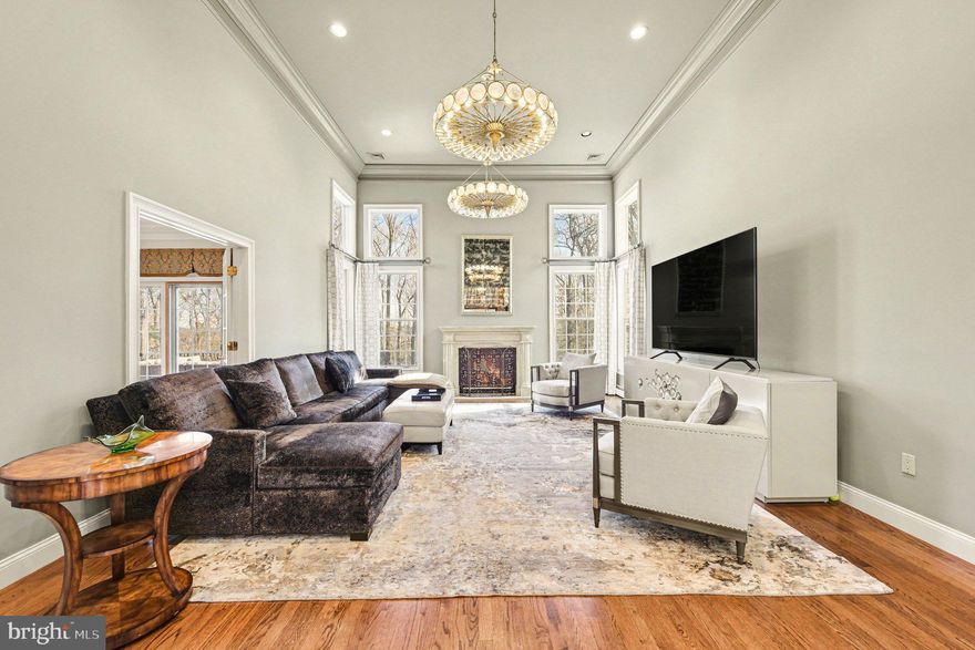 Please begin with the property video tour for an exclusive first look inside. Privately positioned on 1.18 acres along a quiet, tree-lined lane just moments from Manufacturers Golf and Country Club, this extraordinary estate represents a rare offering where architectural distinction, uncompromising craftsmanship, and timeless elegance converge. Custom built by its original owner, the residence is a true legacy property, stately in presence, beautifully composed, and set within one of the area’s most desirable and enduring locations.

Inspired by the refined grace of Mizner-influenced design, the home embodies a level of quality and execution seldom found in the surrounding market. Every detail has been meticulously considered, every finish deliberately selected, and only the most skilled, top-tier artisans and contractors were entrusted in its creation, resulting in a standard of construction that is truly without equal in the area.

From the moment of arrival, the experience is both grand and inviting. A dramatic foyer with soaring 20-foot ceilings introduces artisan ceiling treatments, intricate crown moldings, and radiant heated marble floors that extend throughout the entry and hallways, setting the tone for interiors that are as thoughtful as they are impressive. Expansive windows flood the main level with natural light, illuminating gallery-like walls perfectly suited for art collectors and connoisseurs.

The formal living and dining rooms offer elegant settings for both intimate moments and refined entertaining, while the soaring family room, anchored by a custom-carved marble fireplace, balances grandeur with warmth. The kitchen is a masterclass in both design and function, featuring exquisite bird’s-eye maple cabinetry, professional-grade appliances, and beautifully integrated spaces for gathering and entertaining. A sunlit breakfast area opens seamlessly to a deck overlooking a preserved bird sanctuary, offering a tranquil backdrop for everyday living.

The main-level primary suite is a private sanctuary of comfort and sophistication, complete with bespoke detailing, dual walk-in closets, and a spa-inspired marble bath with heated floors and luxurious finishes throughout.

Upstairs, well-appointed guest accommodations offer comfort and privacy, while the expansive, walkout lower level presents a fully realized extension of the home, featuring an in-law suite, office, fitness room, and direct access to the grounds, with ample space to envision a future pool.

Impeccably maintained and thoughtfully equipped with multi-zone climate control, radiant heat, integrated sound, and numerous high-performance systems, the home ensures effortless living at every turn. An expansive driveway accommodating up to six vehicles further enhances both convenience and presentation.

Enhanced by a favorable, reduced-rate tax structure, this offering delivers not only exceptional luxury, but enduring value. A residence of this caliber, defined by authenticity, architectural integrity, and extraordinary attention to detail, presents a rare opportunity to own a truly distinguished estate. Comparative Market Analysis  report included.