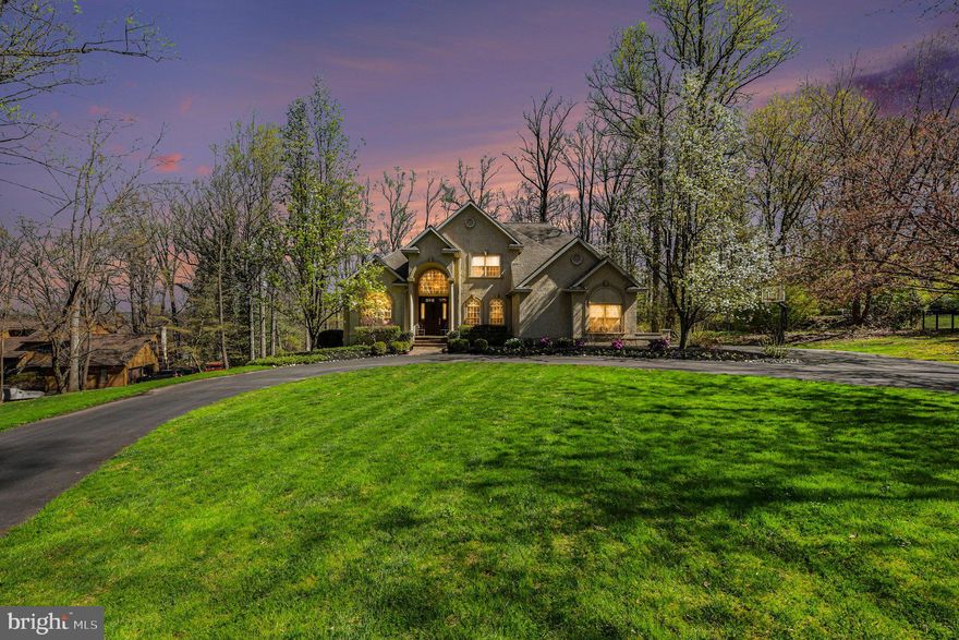 Please begin with the property video tour for an exclusive first look inside. Privately positioned on 1.18 acres along a quiet, tree-lined lane just moments from Manufacturers Golf and Country Club, this extraordinary estate represents a rare offering where architectural distinction, uncompromising craftsmanship, and timeless elegance converge. Custom built by its original owner, the residence is a true legacy property, stately in presence, beautifully composed, and set within one of the area’s most desirable and enduring locations.

Inspired by the refined grace of Mizner-influenced design, the home embodies a level of quality and execution seldom found in the surrounding market. Every detail has been meticulously considered, every finish deliberately selected, and only the most skilled, top-tier artisans and contractors were entrusted in its creation, resulting in a standard of construction that is truly without equal in the area.

From the moment of arrival, the experience is both grand and inviting. A dramatic foyer with soaring 20-foot ceilings introduces artisan ceiling treatments, intricate crown moldings, and radiant heated marble floors that extend throughout the entry and hallways, setting the tone for interiors that are as thoughtful as they are impressive. Expansive windows flood the main level with natural light, illuminating gallery-like walls perfectly suited for art collectors and connoisseurs.

The formal living and dining rooms offer elegant settings for both intimate moments and refined entertaining, while the soaring family room, anchored by a custom-carved marble fireplace, balances grandeur with warmth. The kitchen is a masterclass in both design and function, featuring exquisite bird’s-eye maple cabinetry, professional-grade appliances, and beautifully integrated spaces for gathering and entertaining. A sunlit breakfast area opens seamlessly to a deck overlooking a preserved bird sanctuary, offering a tranquil backdrop for everyday living.

The main-level primary suite is a private sanctuary of comfort and sophistication, complete with bespoke detailing, dual walk-in closets, and a spa-inspired marble bath with heated floors and luxurious finishes throughout.

Upstairs, well-appointed guest accommodations offer comfort and privacy, while the expansive, walkout lower level presents a fully realized extension of the home, featuring an in-law suite, office, fitness room, and direct access to the grounds, with ample space to envision a future pool.

Impeccably maintained and thoughtfully equipped with multi-zone climate control, radiant heat, integrated sound, and numerous high-performance systems, the home ensures effortless living at every turn. An expansive driveway accommodating up to six vehicles further enhances both convenience and presentation.

Enhanced by a favorable, reduced-rate tax structure, this offering delivers not only exceptional luxury, but enduring value. A residence of this caliber, defined by authenticity, architectural integrity, and extraordinary attention to detail, presents a rare opportunity to own a truly distinguished estate. Comparative Market Analysis  report included.