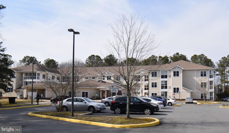 Welcome to the Woodlands at Ocean Pines. featuring independent living condominiums, along with a beautiful Community Center, serviced by professional staff with daily activities, housekeeping service, caregivers, maintenance, elevator access, and a  24/7 front desk.  This is a very large one bedroom and is a  desireable top floor unit with great views of the creek and woods.   This condo is one of the largest 1 bedroom models in the community.  It includes a foyer, living room, dining room, kitchen and sunroom, with a primary bedroom and bath.  This 55 plus community offers a beautiful common area with restaurant and lounge area, card room, movie theatre , nail and beauty salon and much, much more.  There is also a Daily Care Team offering three different levels of assisted living care when/if needed.   This community also belongs to the Ocean Pines association which means you can   have access to the community pools and The Woodlands also offers free transportation to the grocery store. This will not be on the market long and is priced very well.