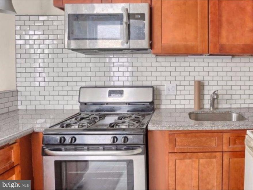 Totally renovated 4 bedroom 1   bath home with huge 4 car garage with oil pit  and work area!  This home features granite countertops & subway tile backsplash, stainless steel appliances in the kitchen.  First floor has ceramic tile floor throughout and a nicely renovated oversized  half bath on the first floor.  3 bedrooms on the 2nd floor and totally renovated full bath with tiled shower and flooring with a beautiful vanity!  The 3rd floor is the 4th large bedroom.  This home features gas heat and cooking and several new replacement windows throughout the home and a new front and back door.  The huge garage is a car enthusiasts dream!!  This garage has a new roof and electric garage door with its own electric panel and service. Perfect to fit 4 cars in this garage with high ceiling and oil pit for repairs.  This home is a must see to appreciate!!!